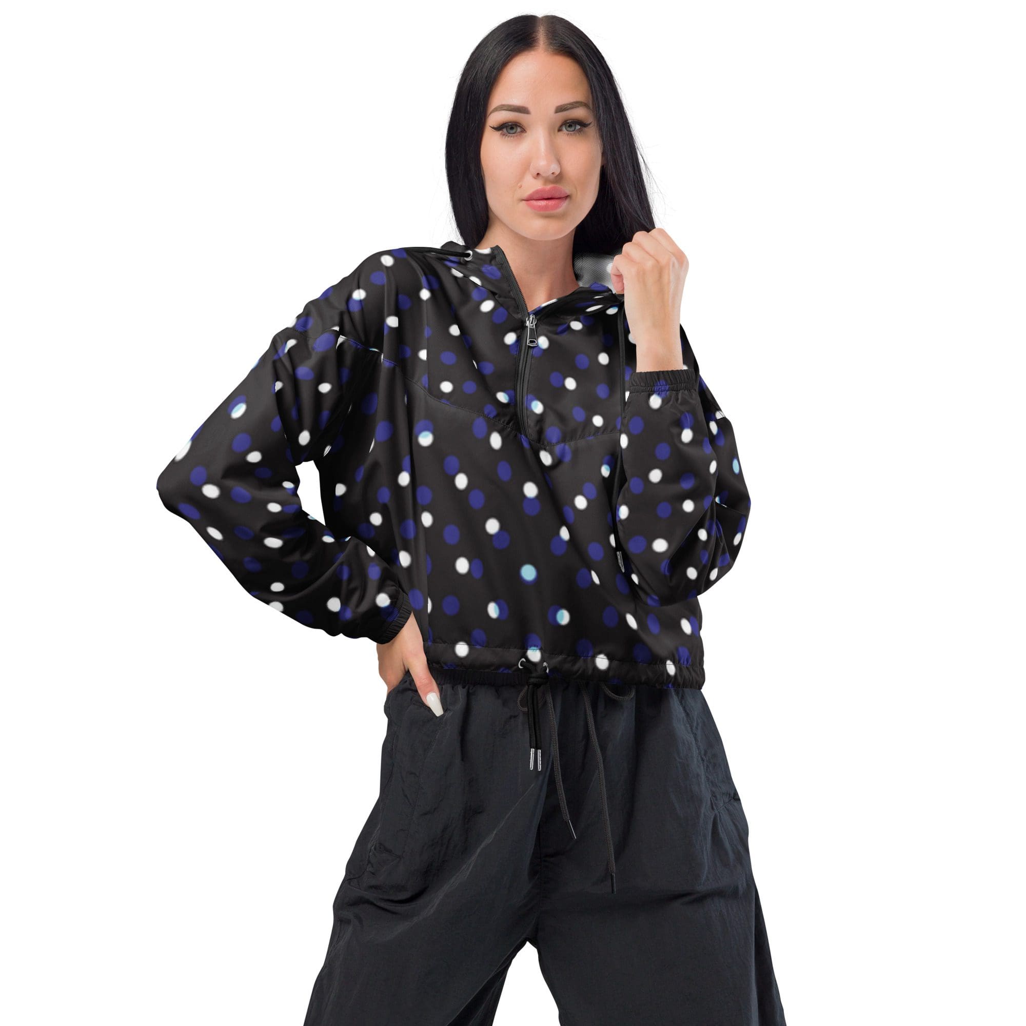 Woman in polka dot jacket posing confidently.