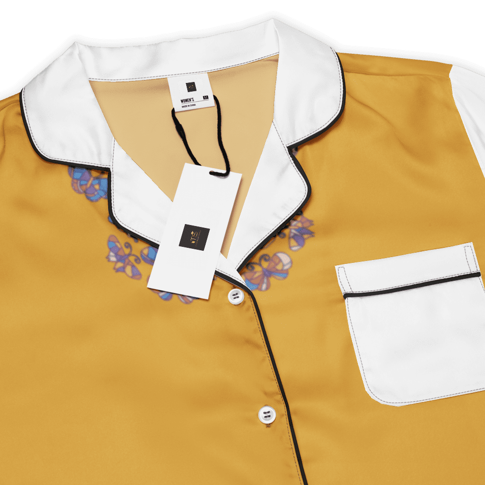 Gold shirt with floral details and tags.