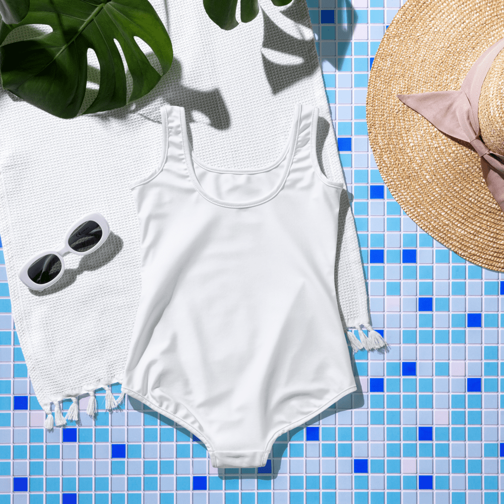 White swimsuit with sunglasses and hat.