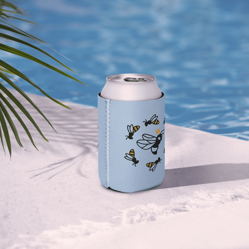 Drink can with bee-themed sleeve by pool.