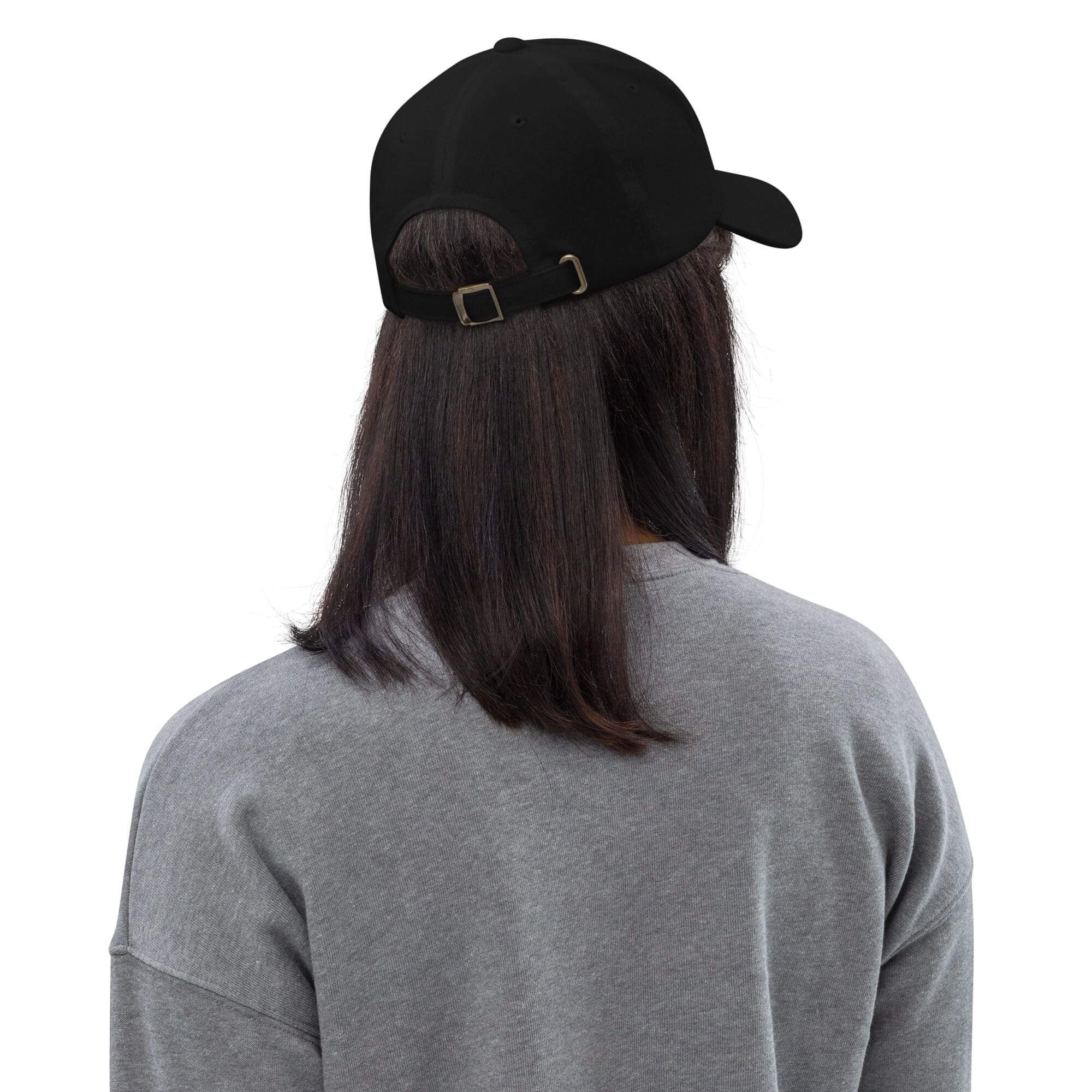 Person wearing black cap and gray sweater.