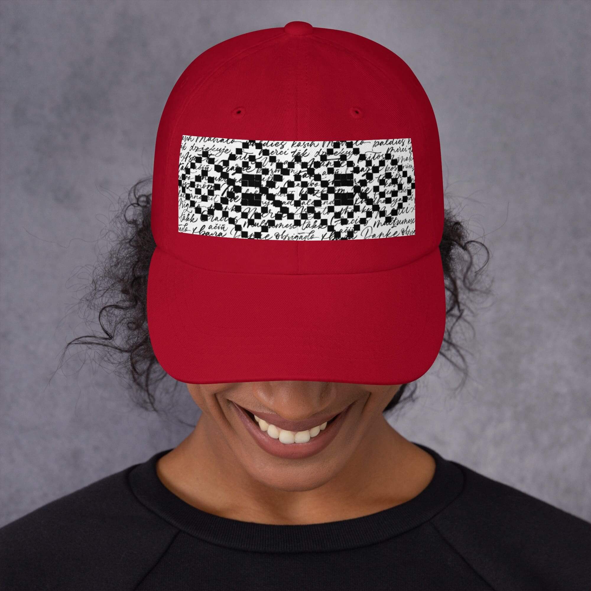Person wearing red hat with geometric design.