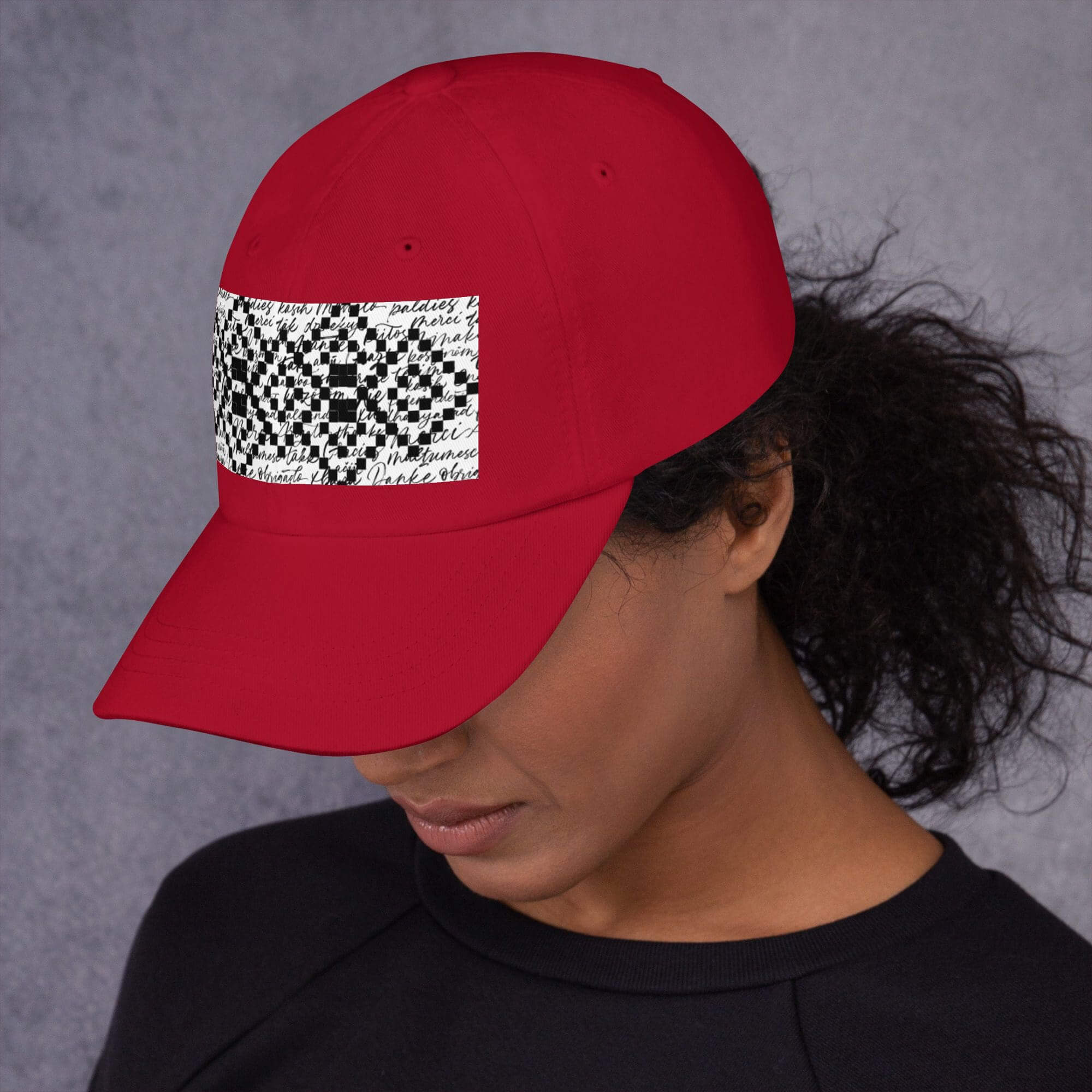 Woman wearing red cap with patterned design.