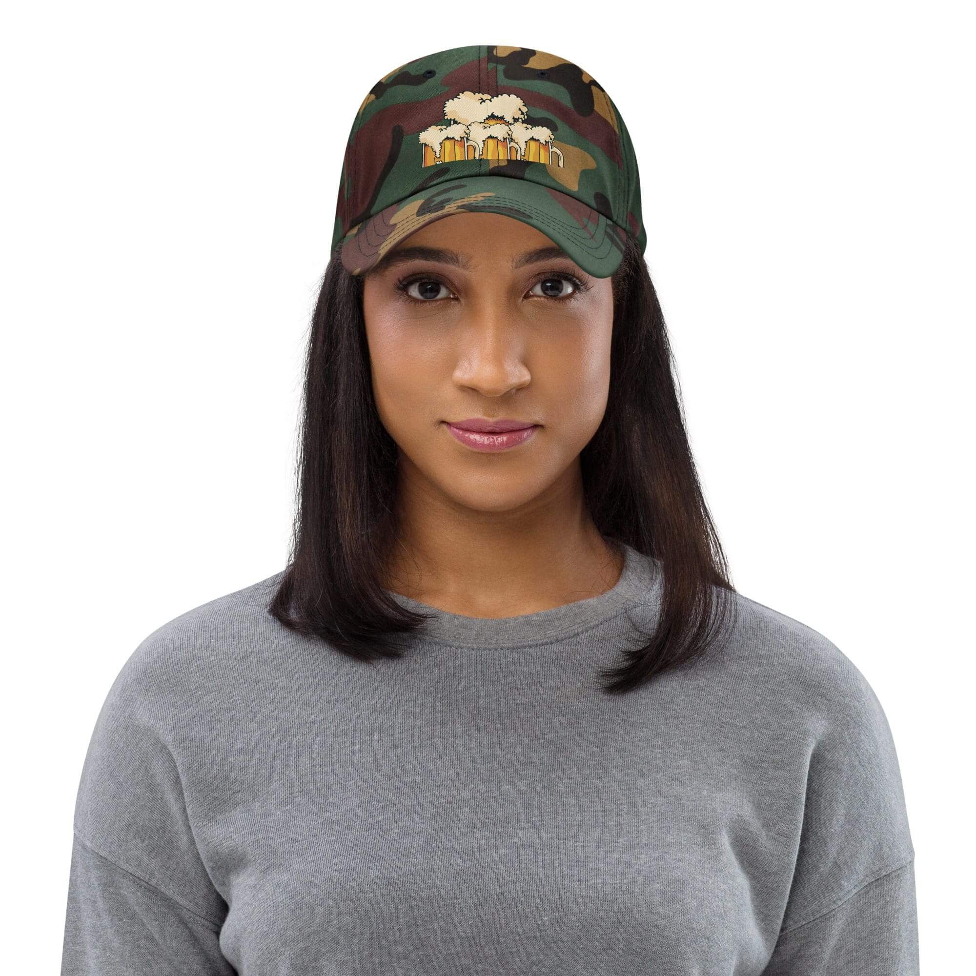 Woman wearing camo cap and gray sweater.