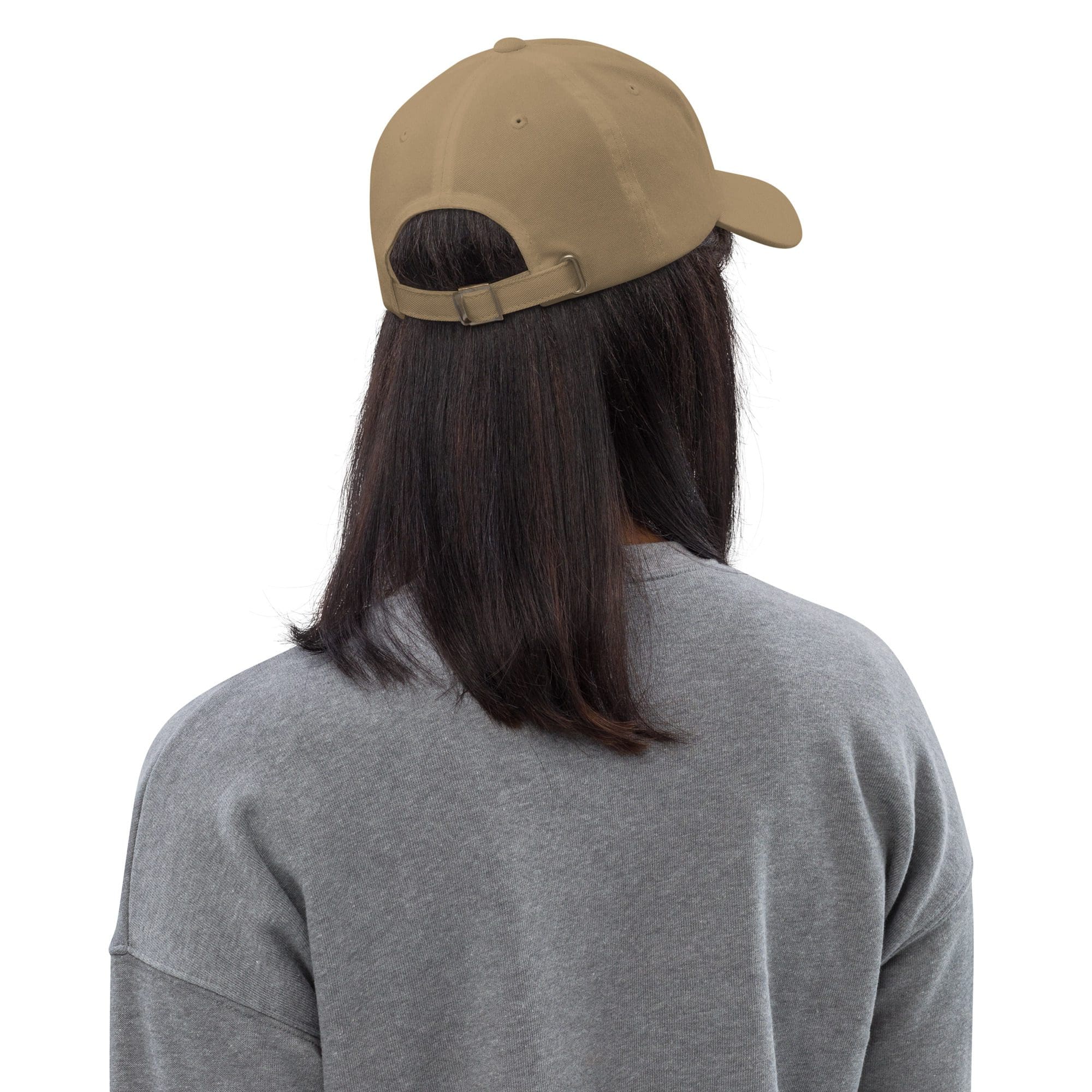Person wearing beige cap and gray sweater.
