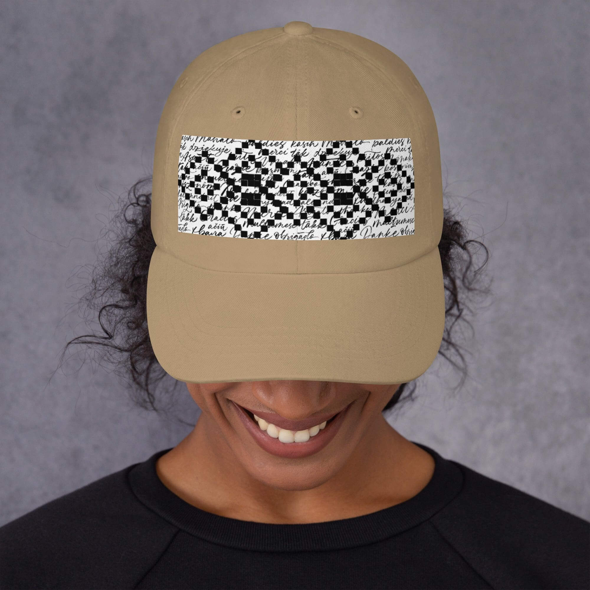 Person wearing beige cap with patterned design.