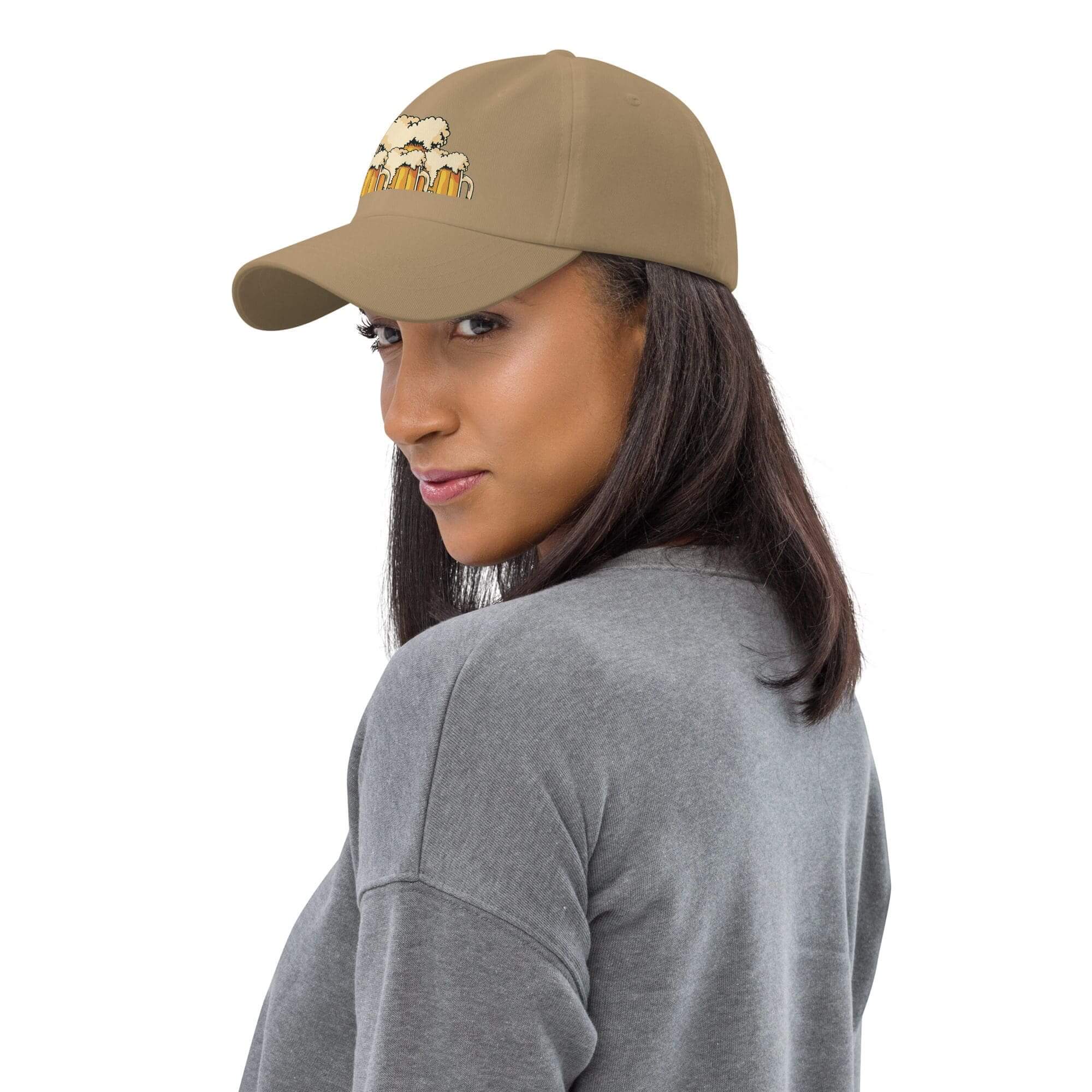 Woman wearing beige hat with design.