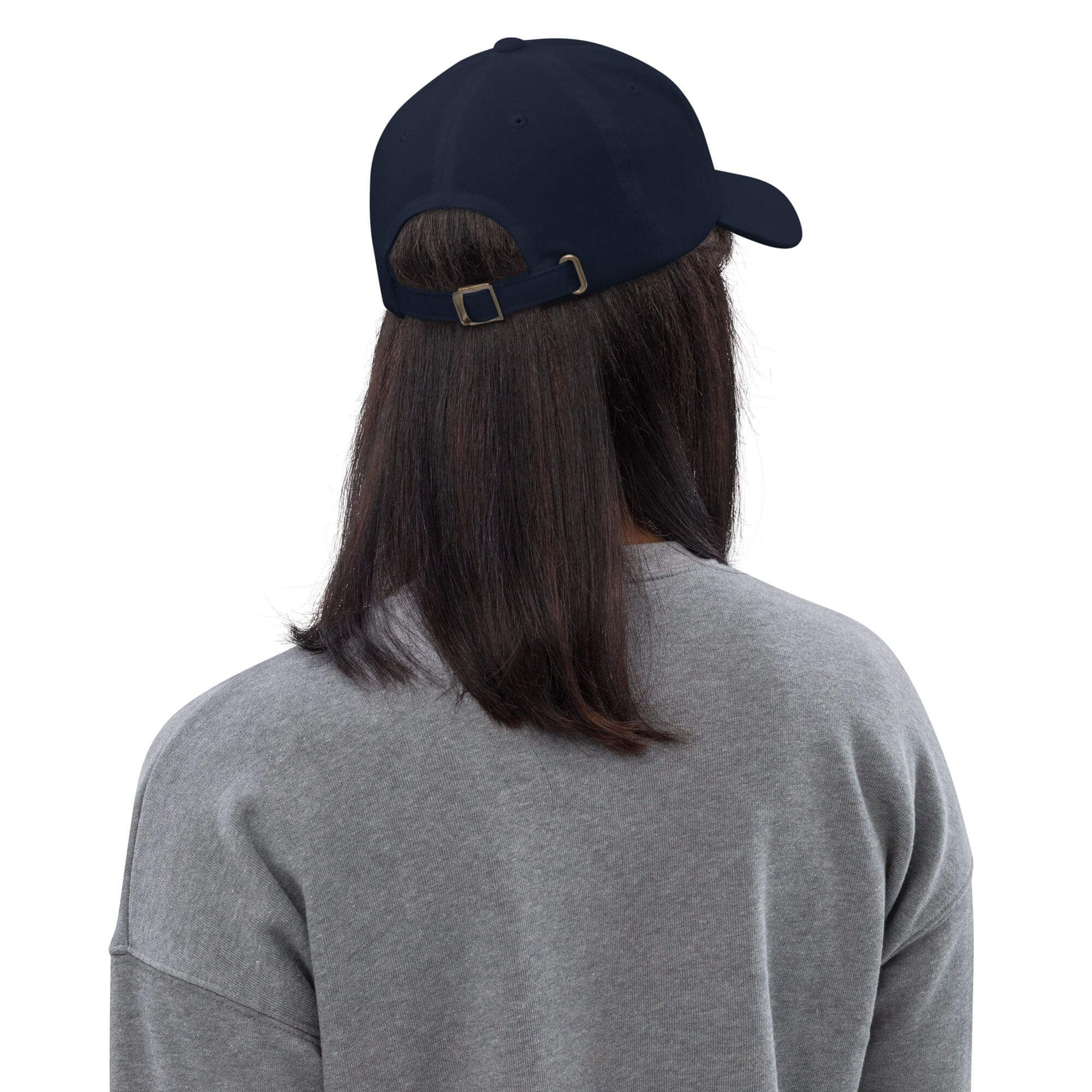 Person wearing a baseball cap, gray sweater.