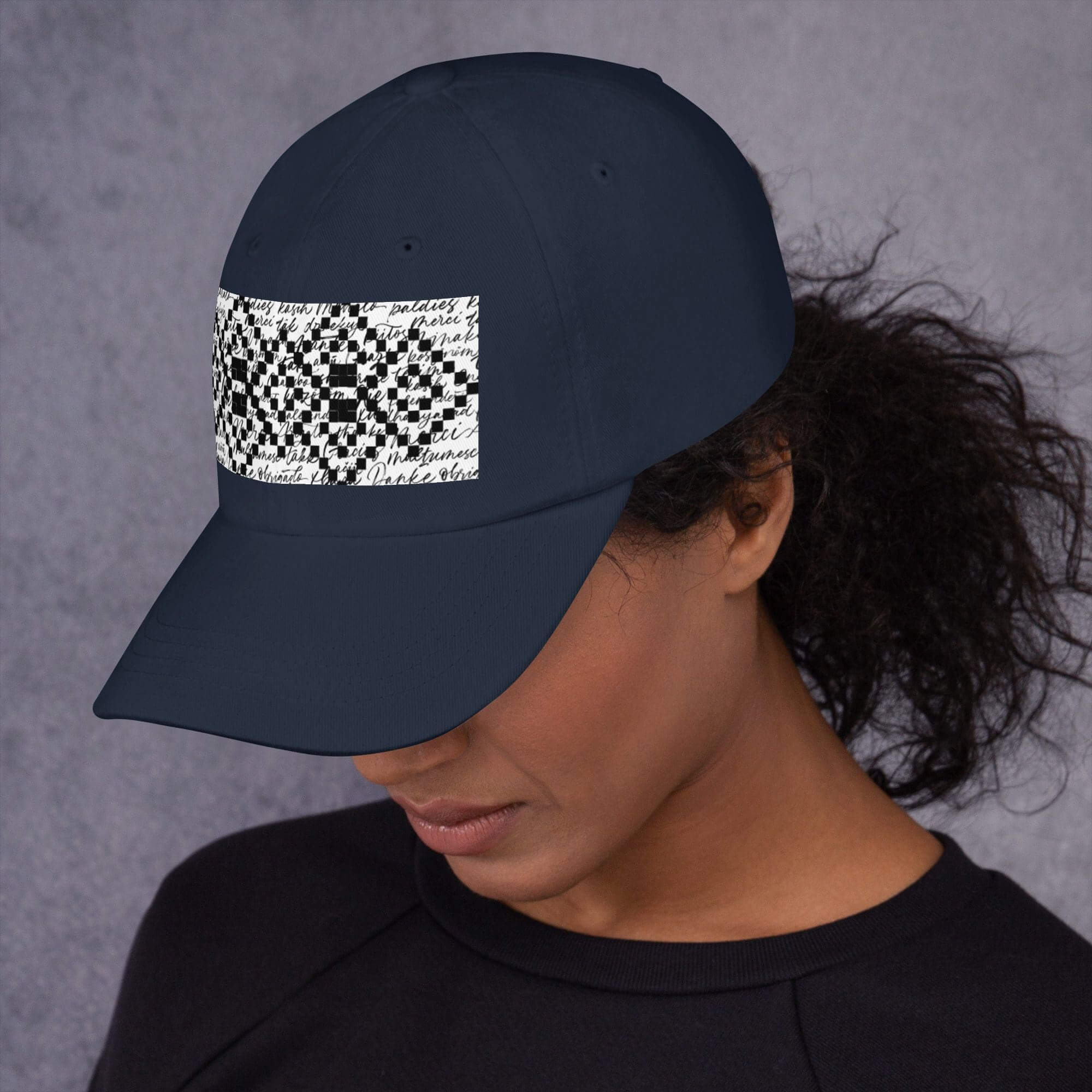 Woman wearing a navy cap with design.