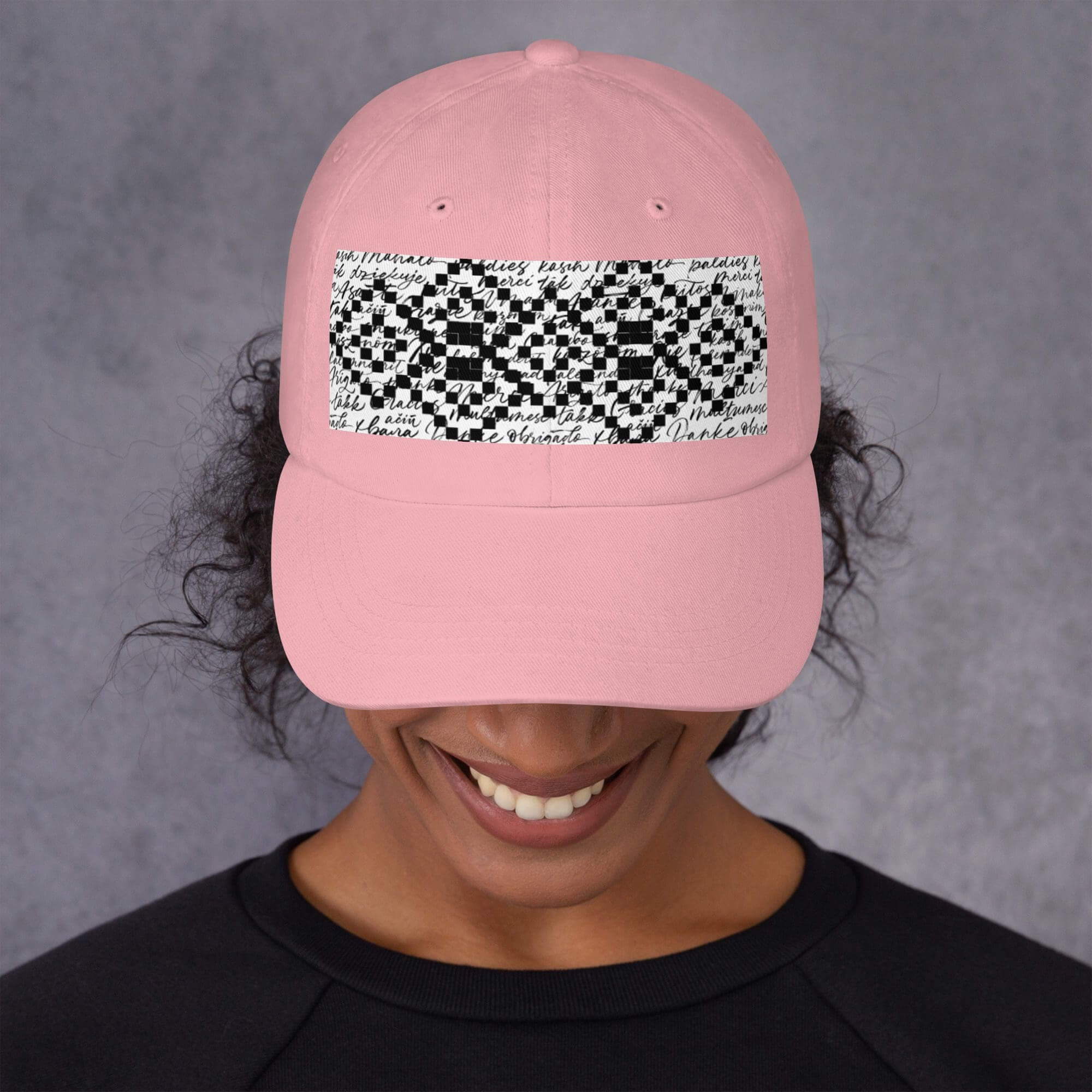 Pink cap with black and white design.