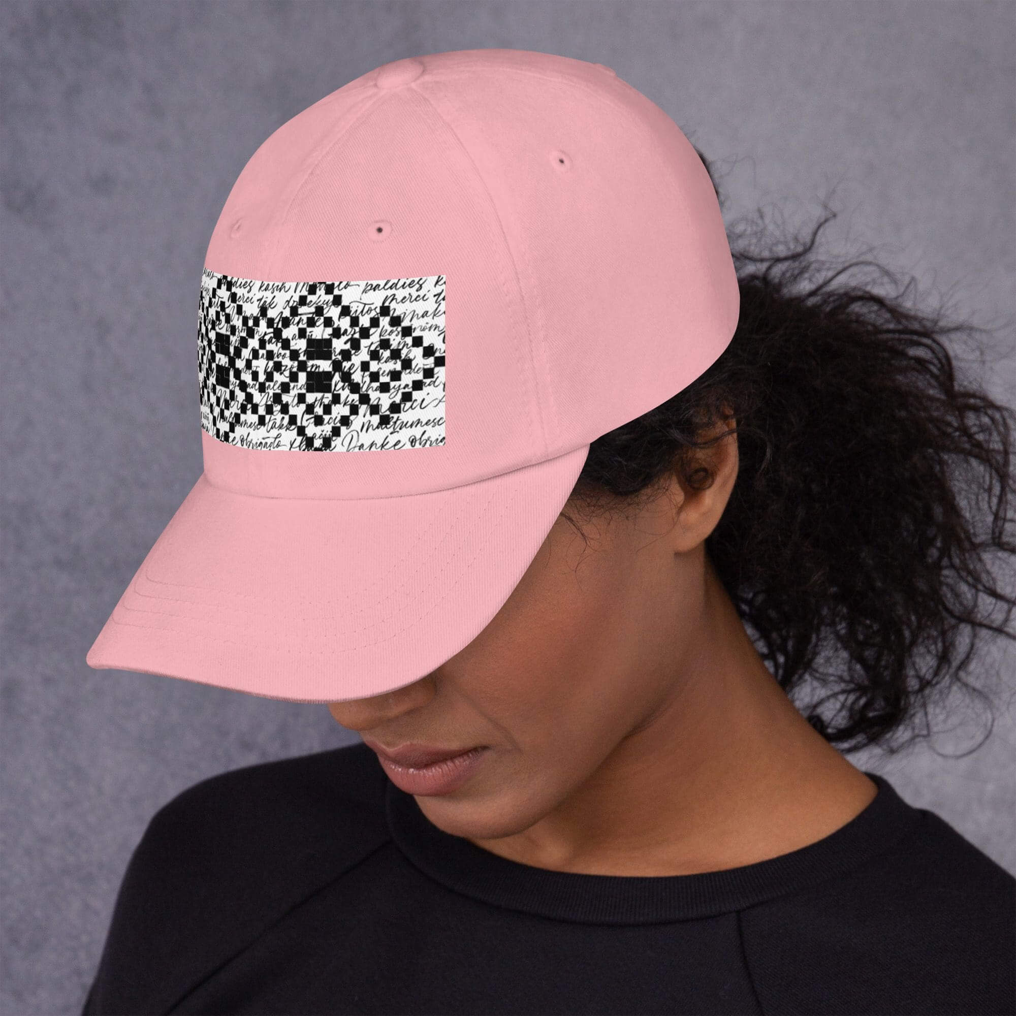 Woman wearing pink cap with patterned design.