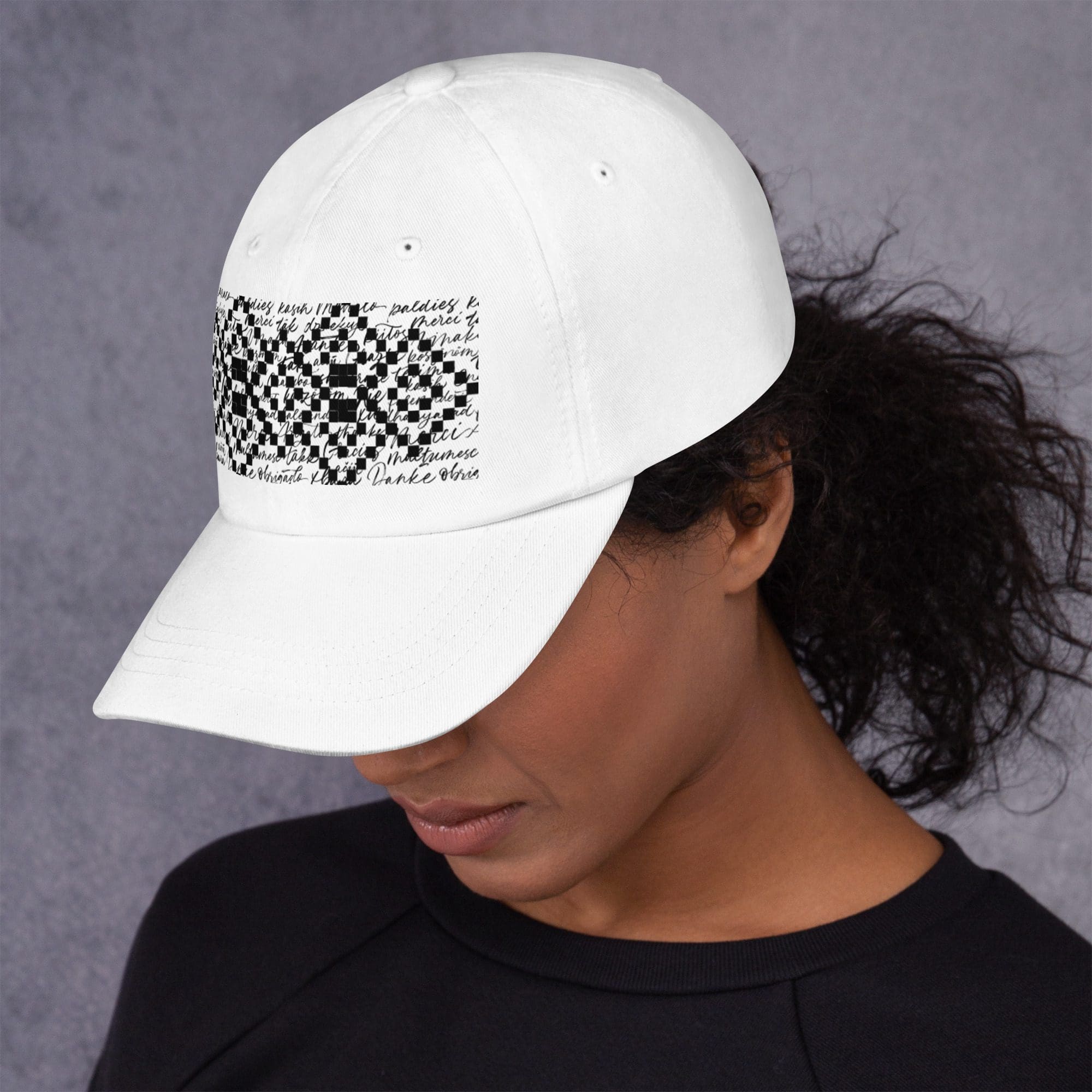 Woman wearing white cap with text design.