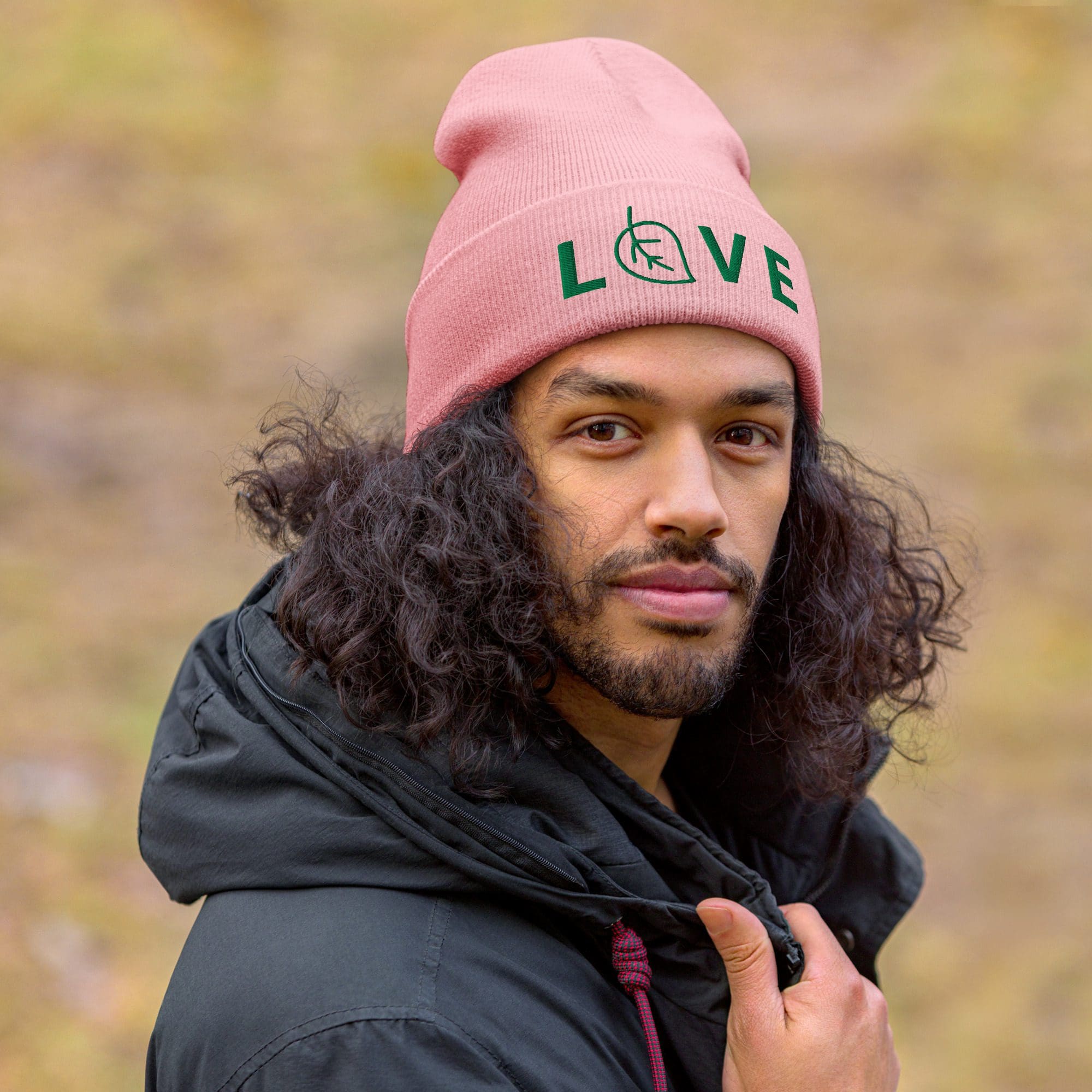 Man wearing pink beanie with "LOVE" text.