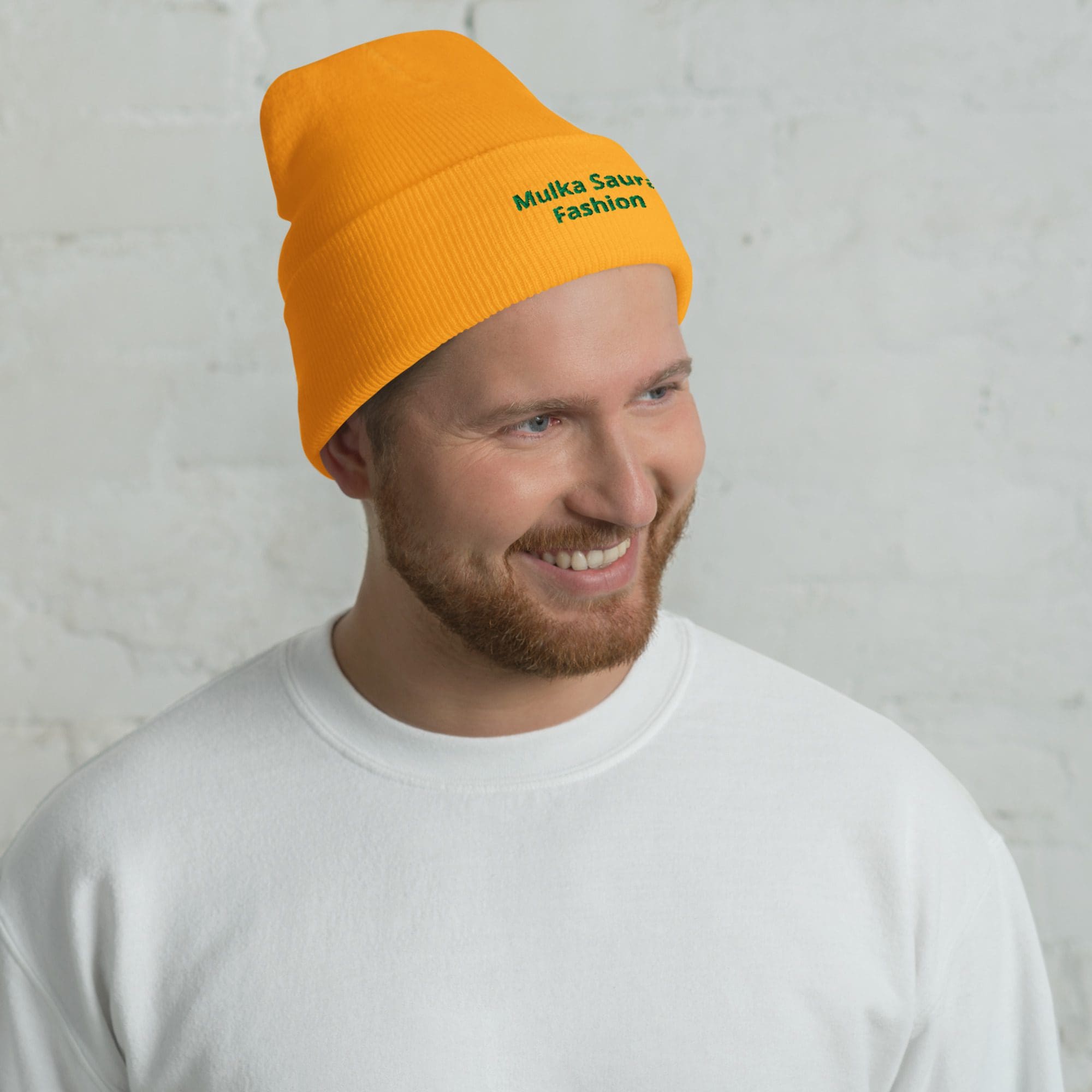Man wearing orange beanie and white shirt.