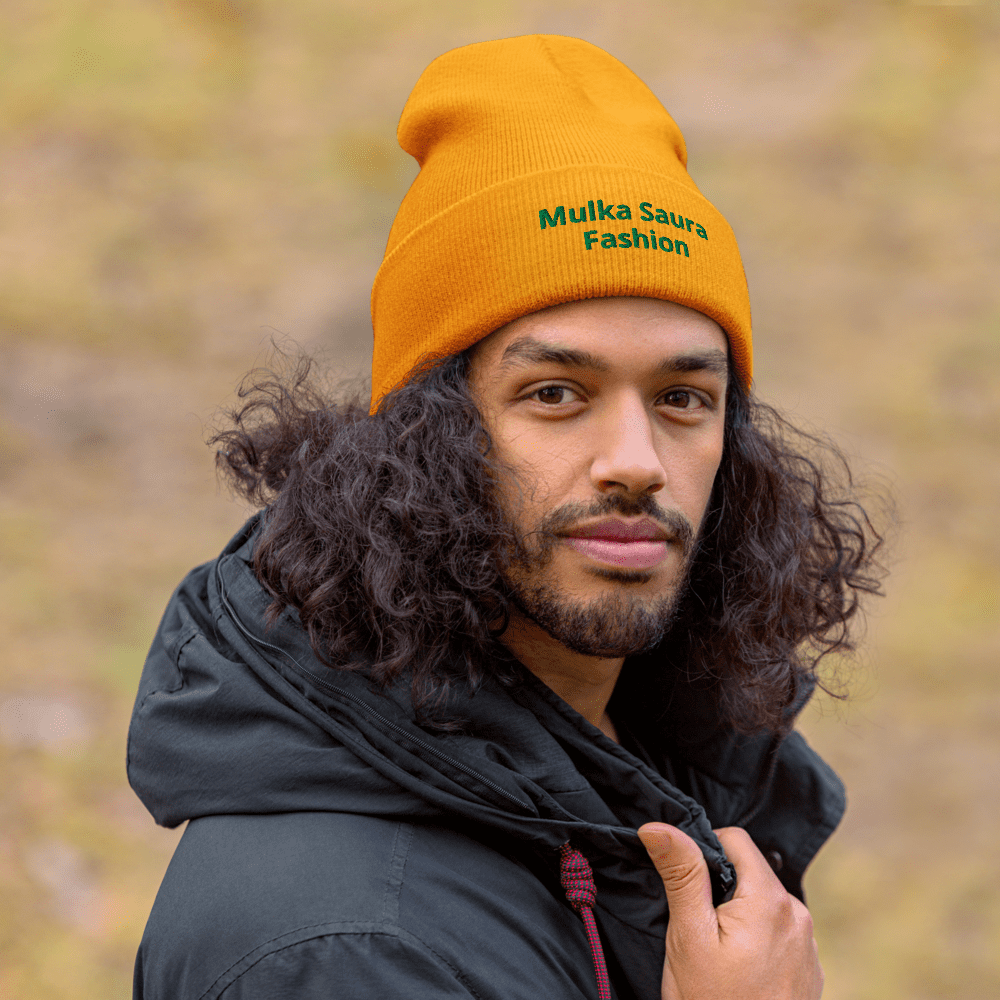 Man wearing orange beanie with logo outside.