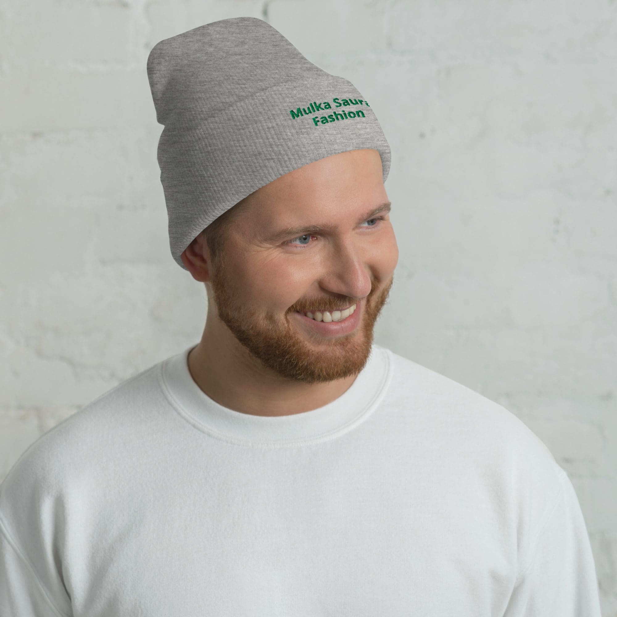 Man wearing gray beanie and white sweatshirt.