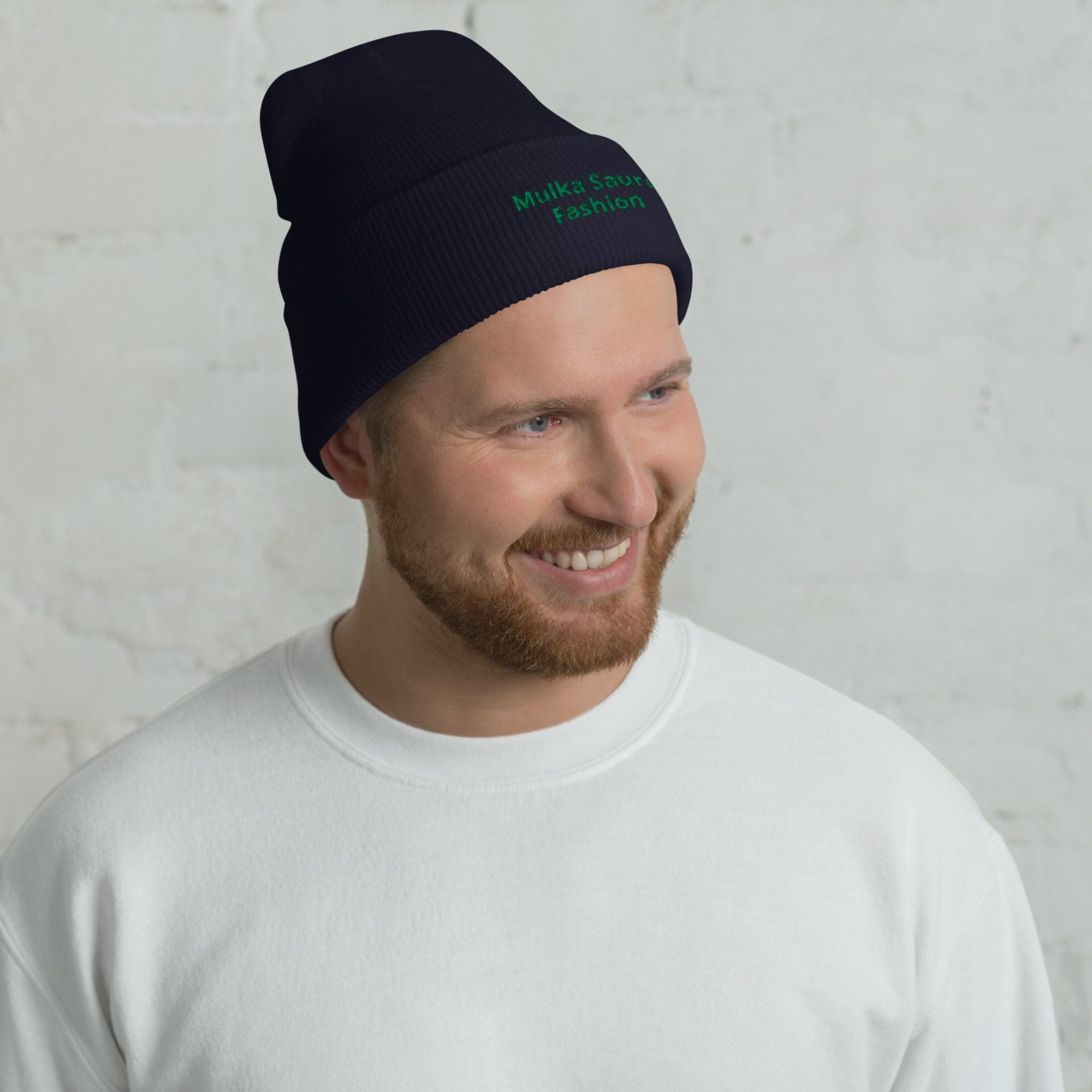 Man wearing beanie and white sweater.