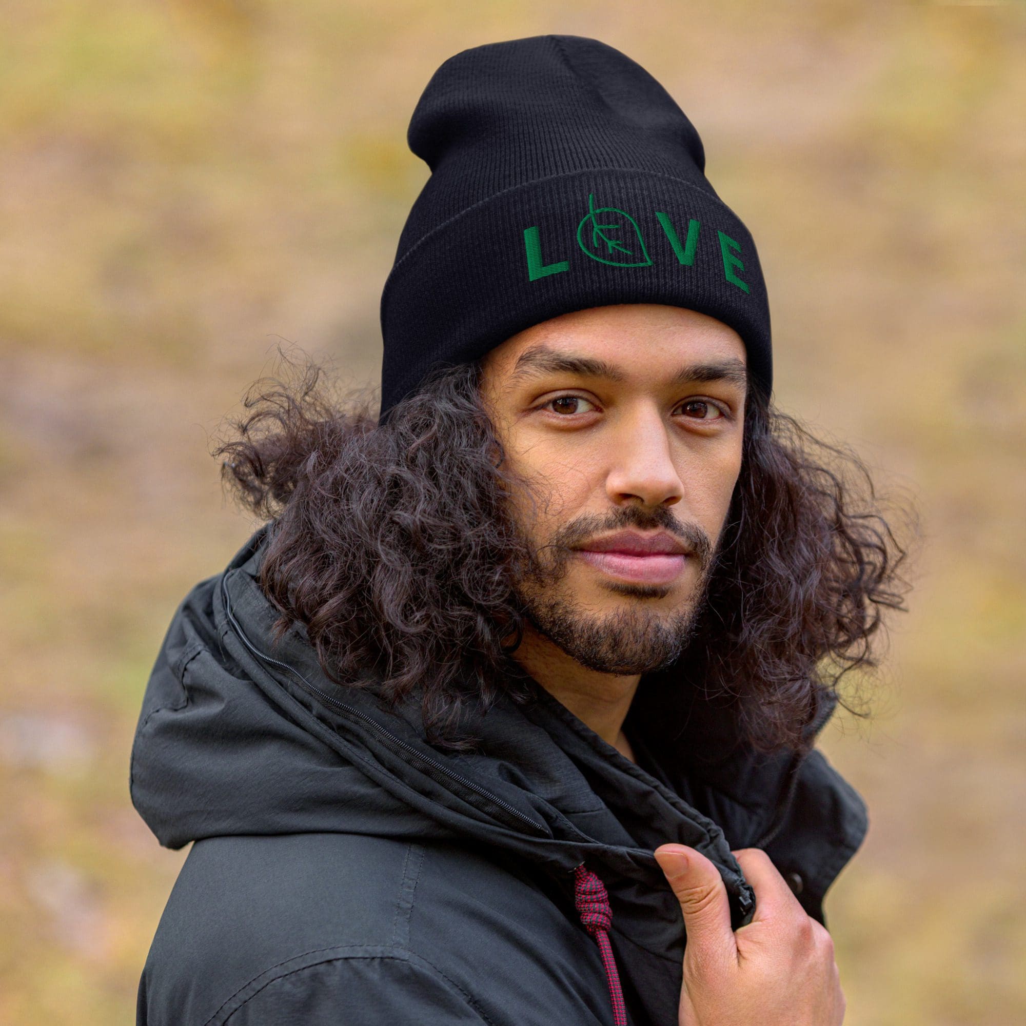 Man wearing beanie with "LOVE" design.