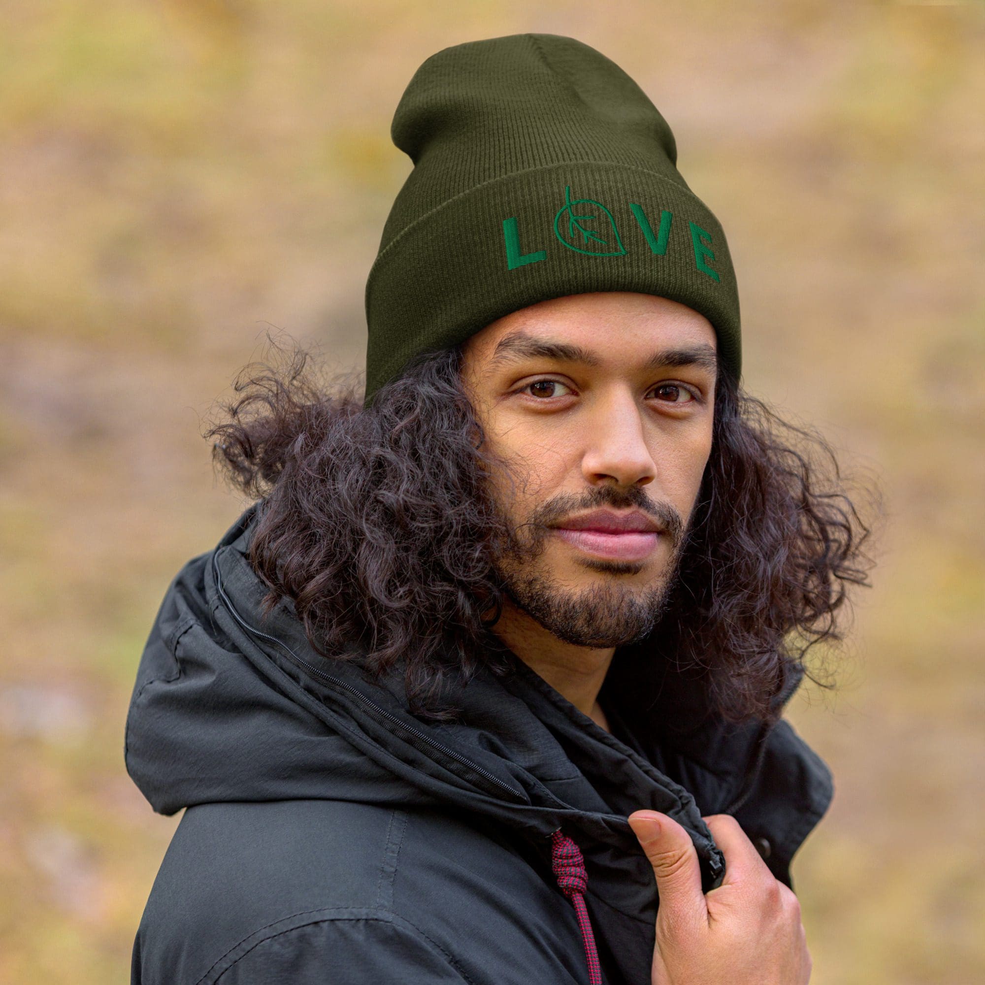 Man wearing green hat with "LOVE" text.