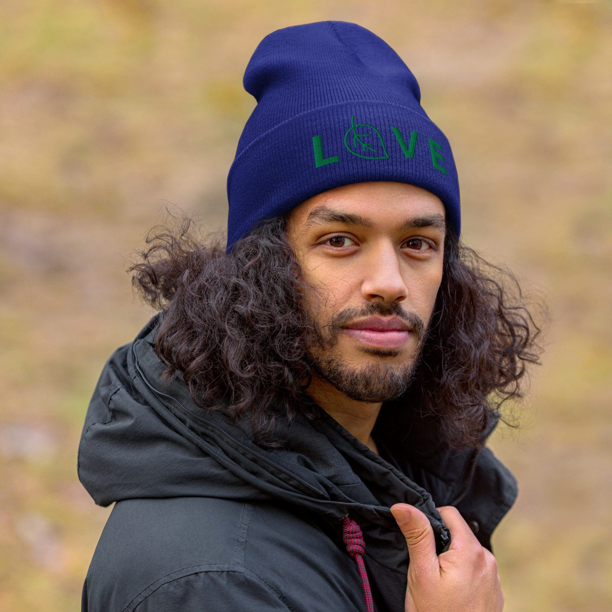 Man wearing blue hat and black jacket.