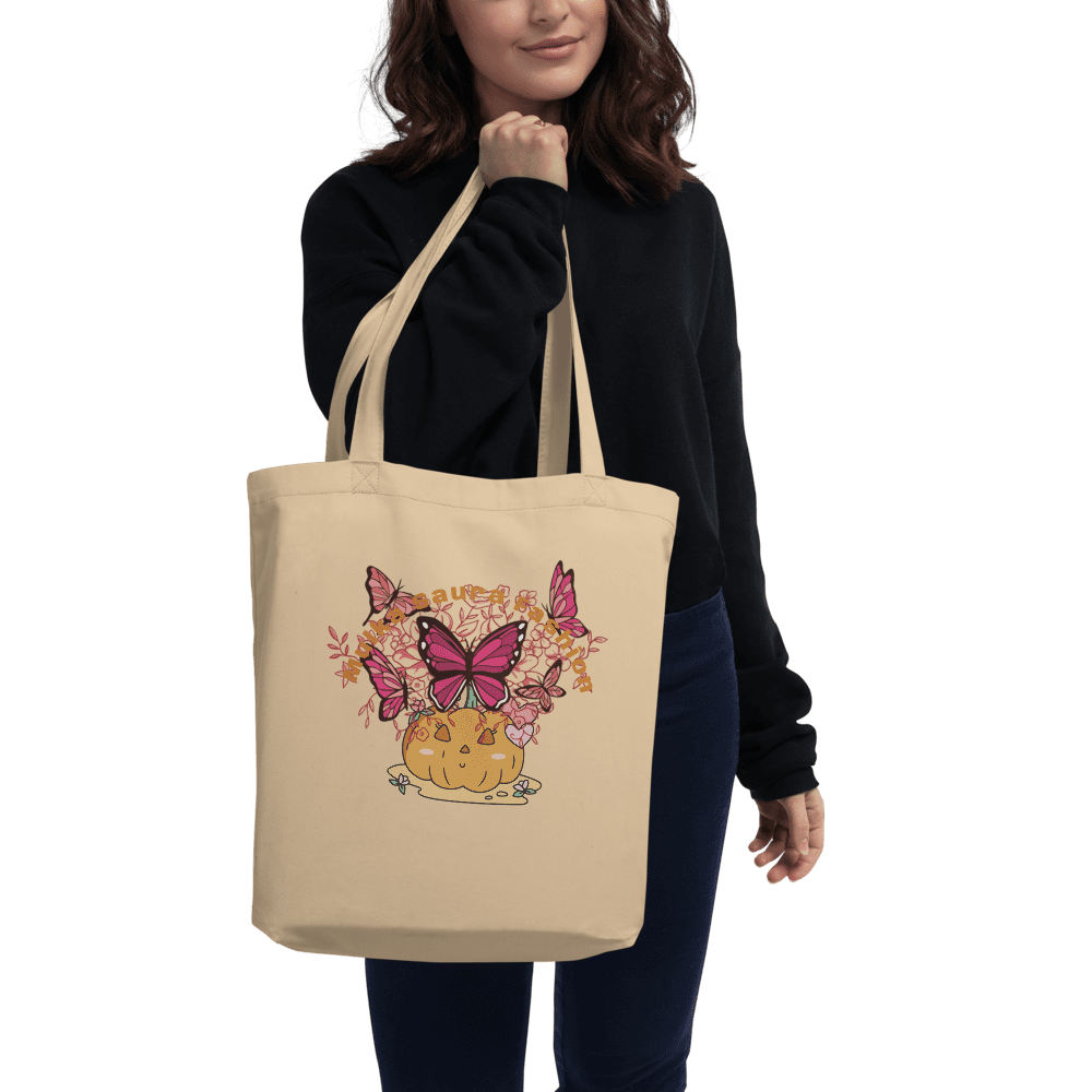Woman holding tote with butterfly pumpkin design