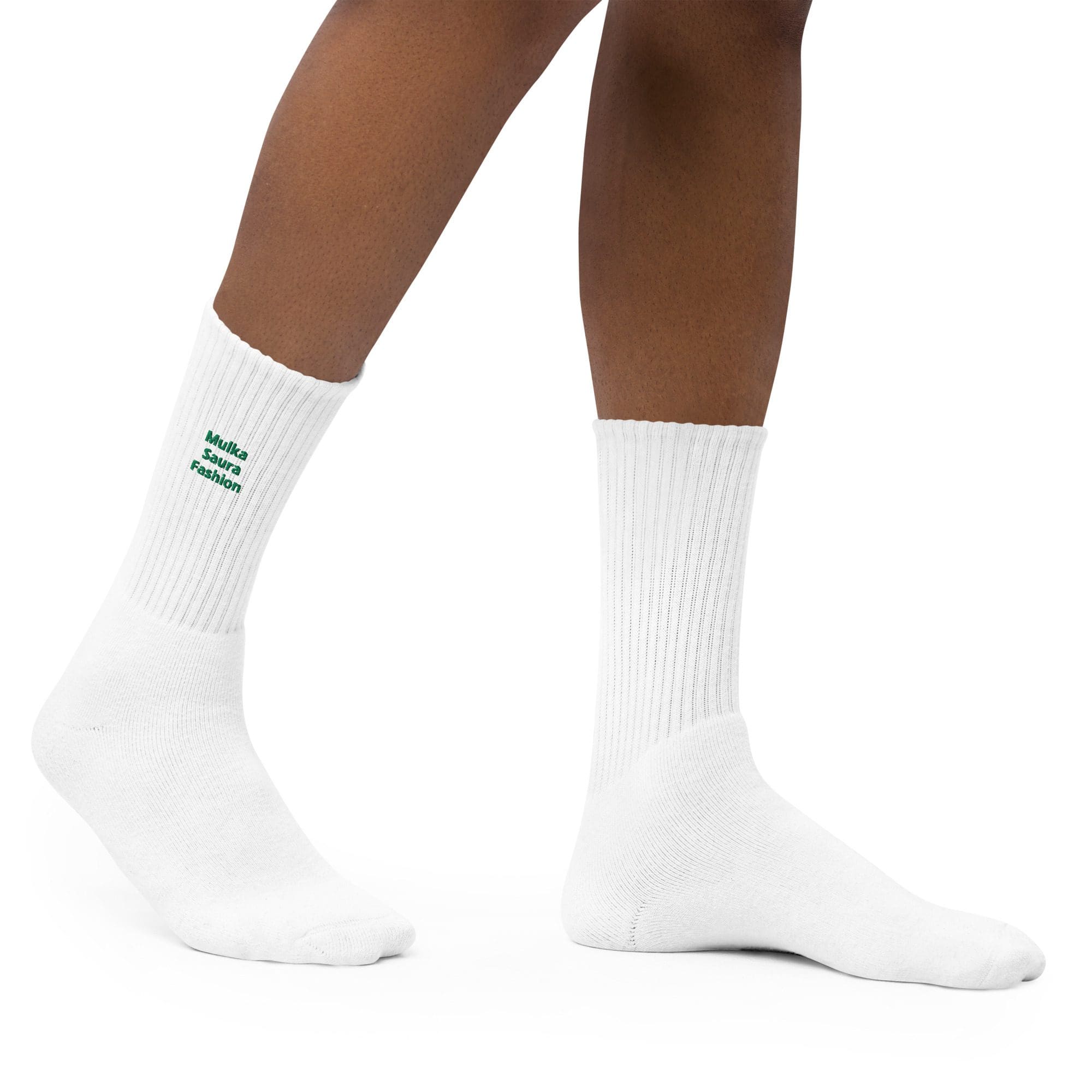 Person wearing white socks with green text.