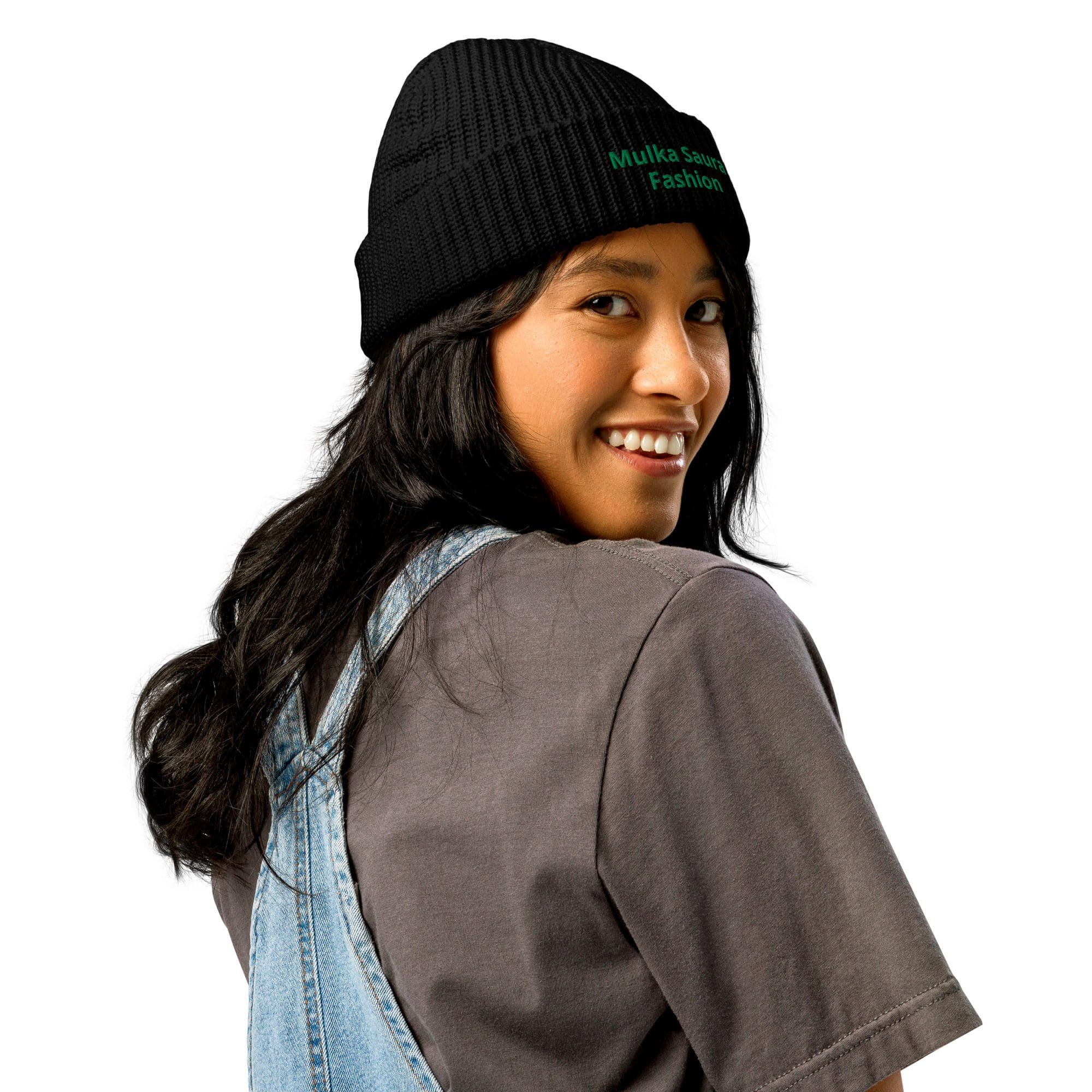 Smiling woman in beanie and overalls.