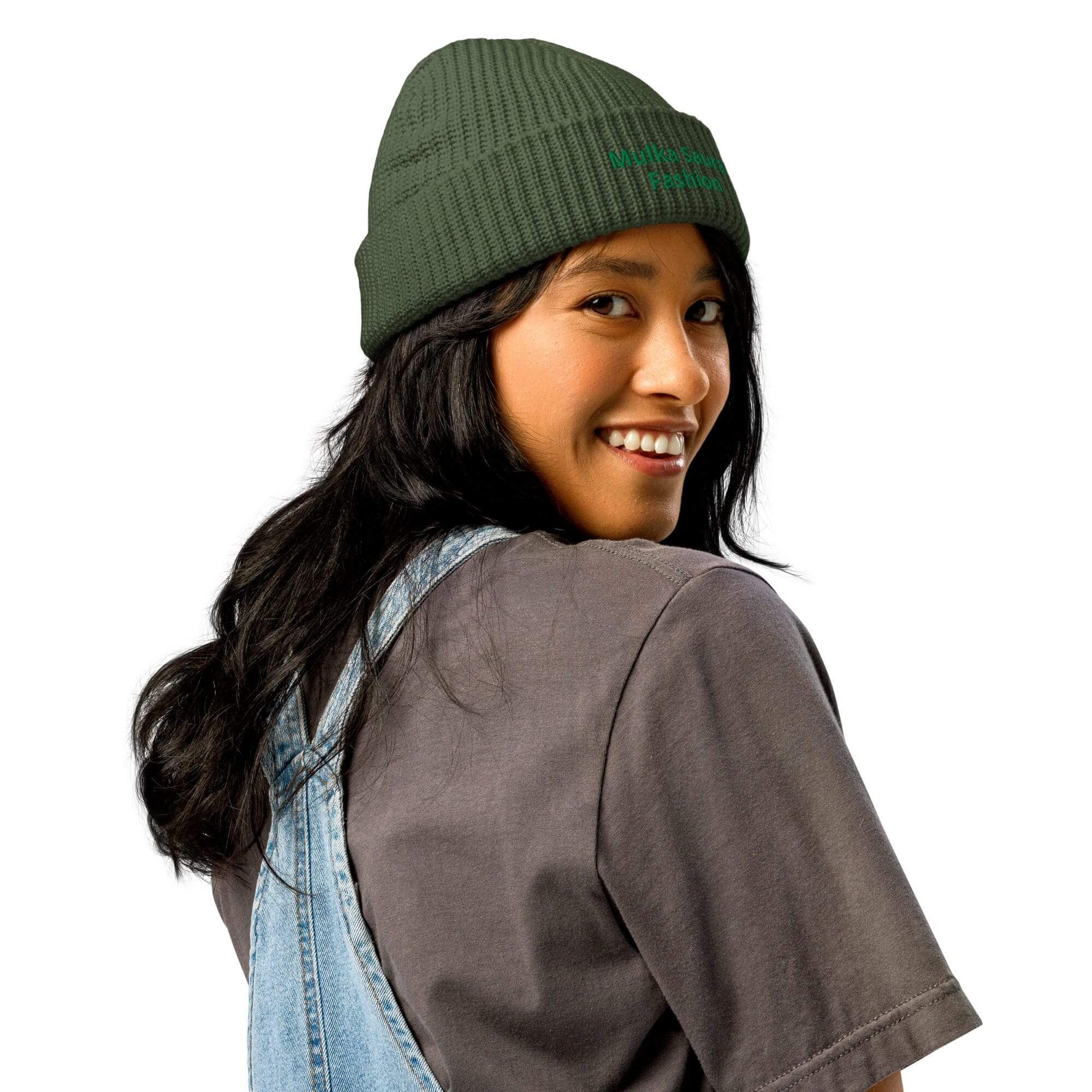 Smiling woman in green beanie and overalls