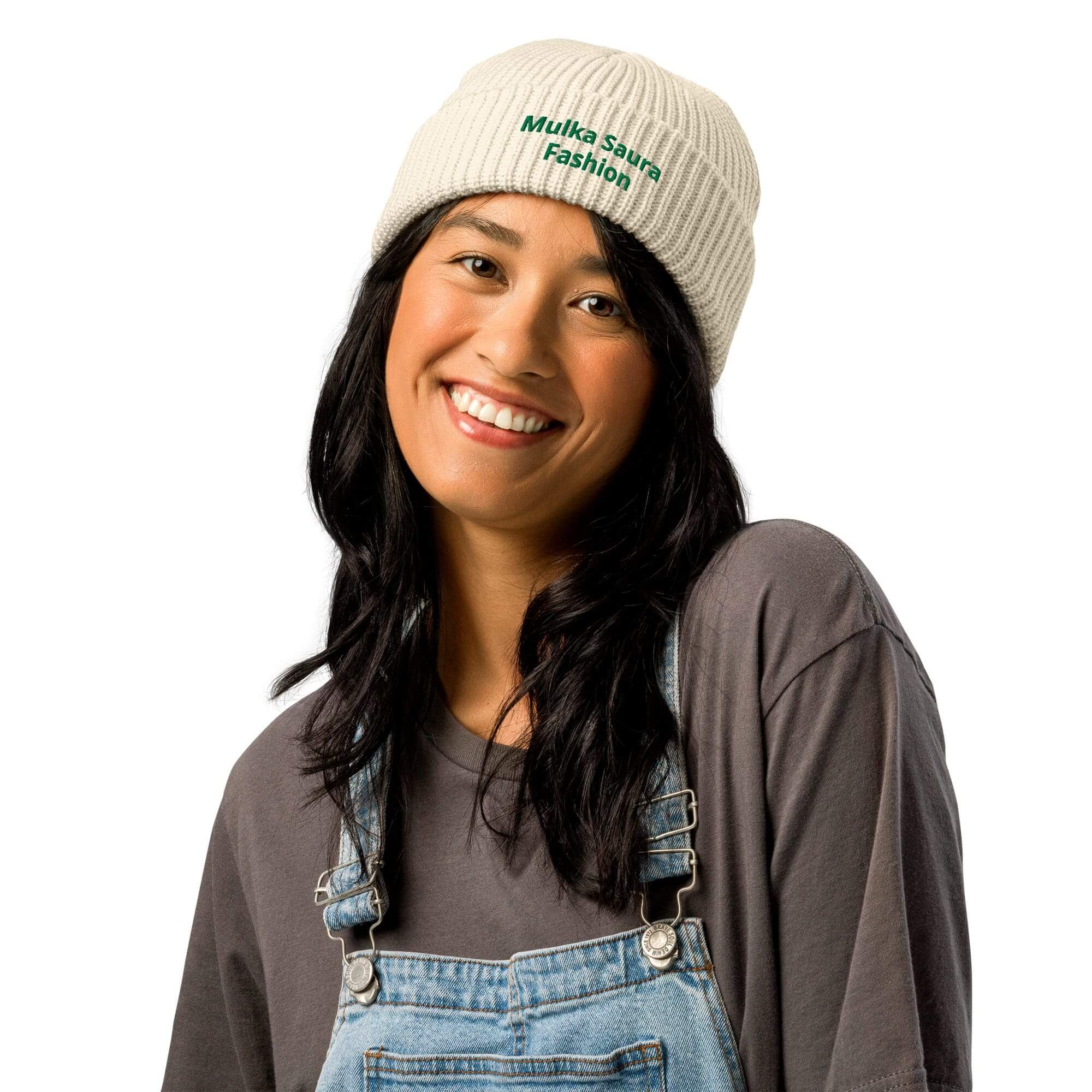 Smiling woman wearing knit beanie and overalls