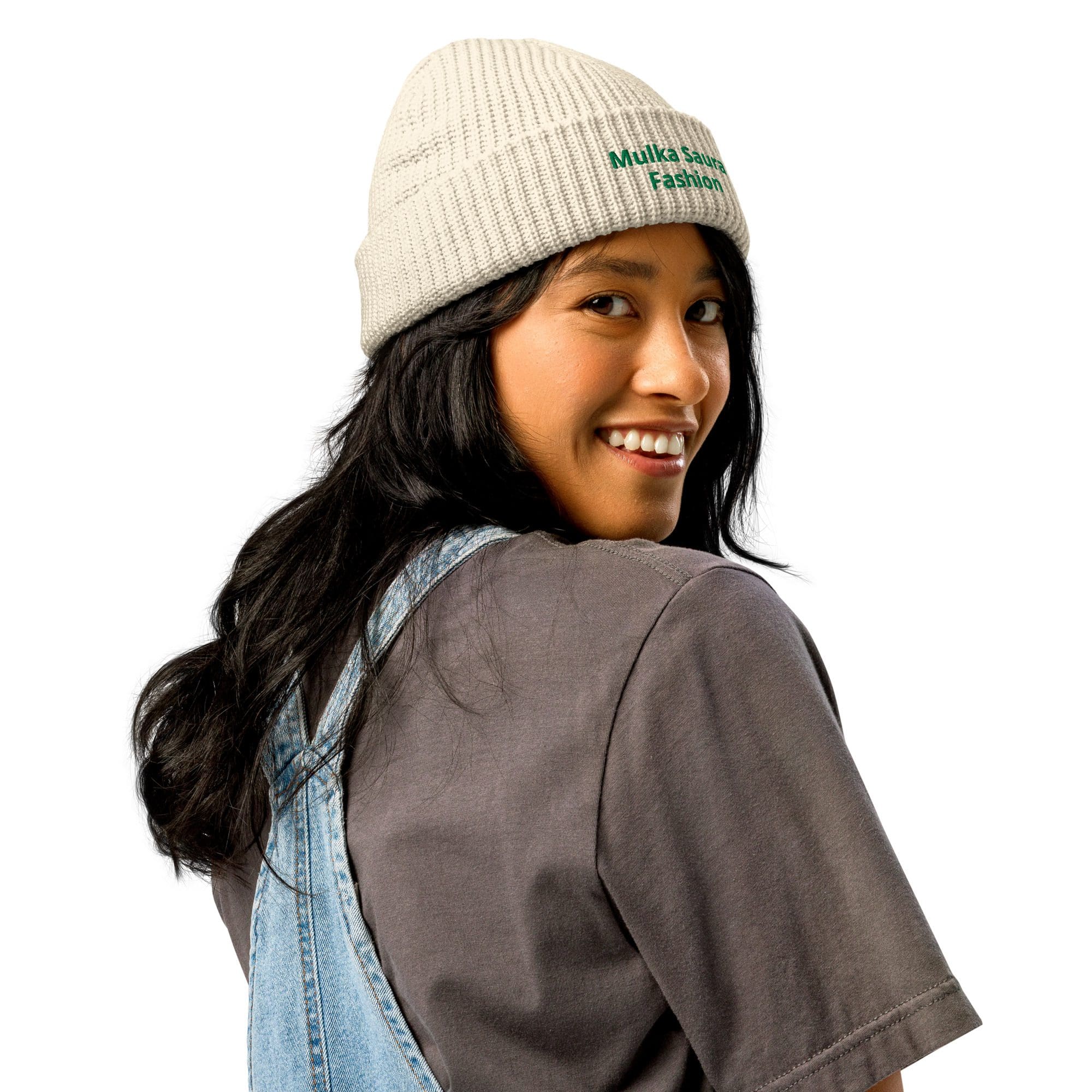 Smiling woman wearing beanie and denim overalls