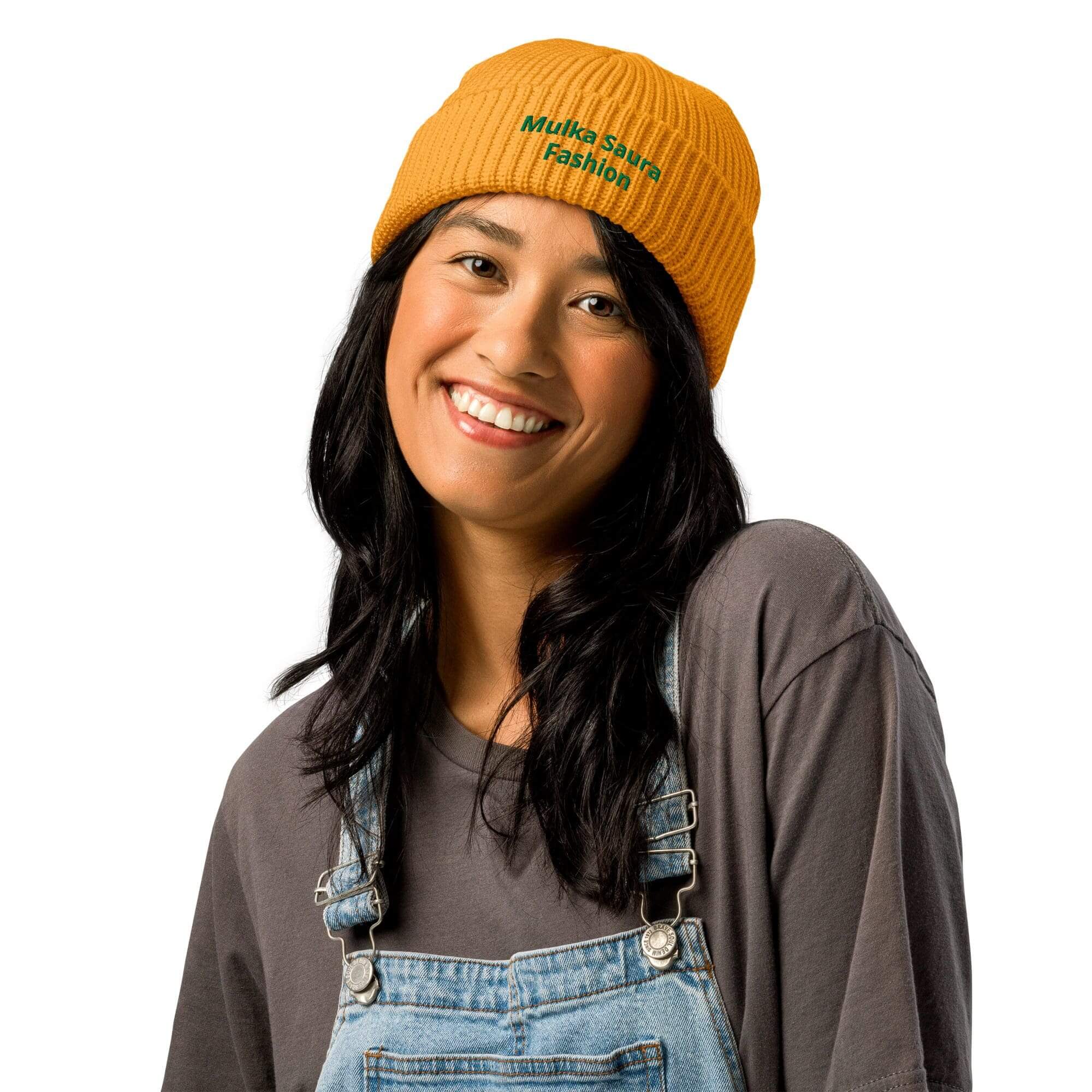 Smiling woman wearing yellow beanie and denim overalls