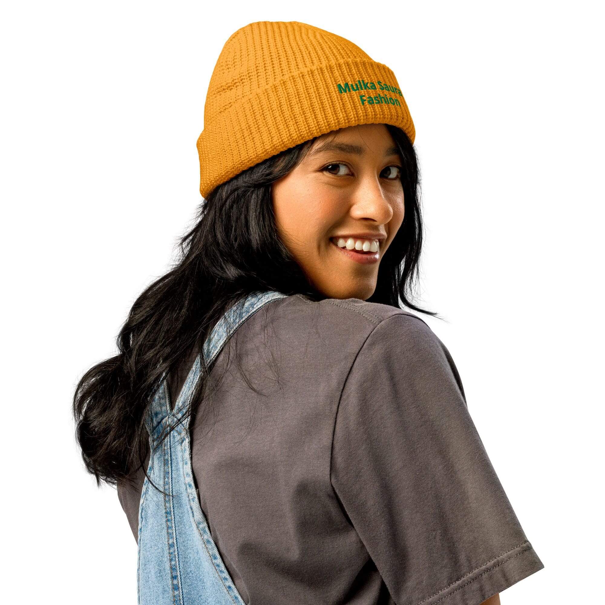Smiling person wearing yellow beanie and overalls.