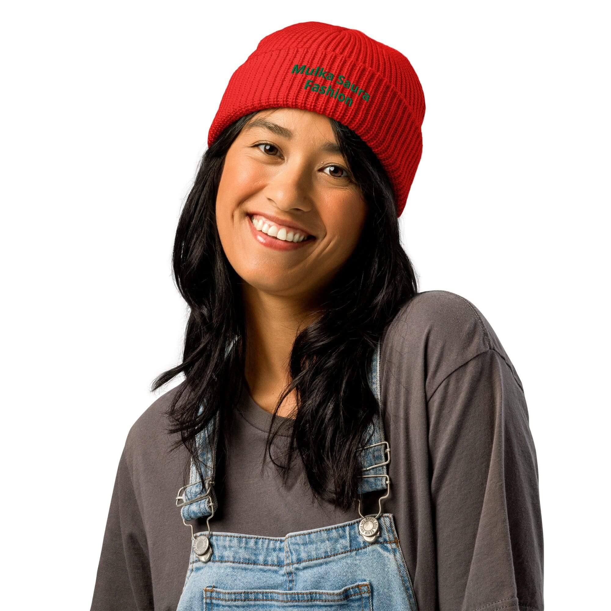 Person smiling, wearing red beanie and overalls.