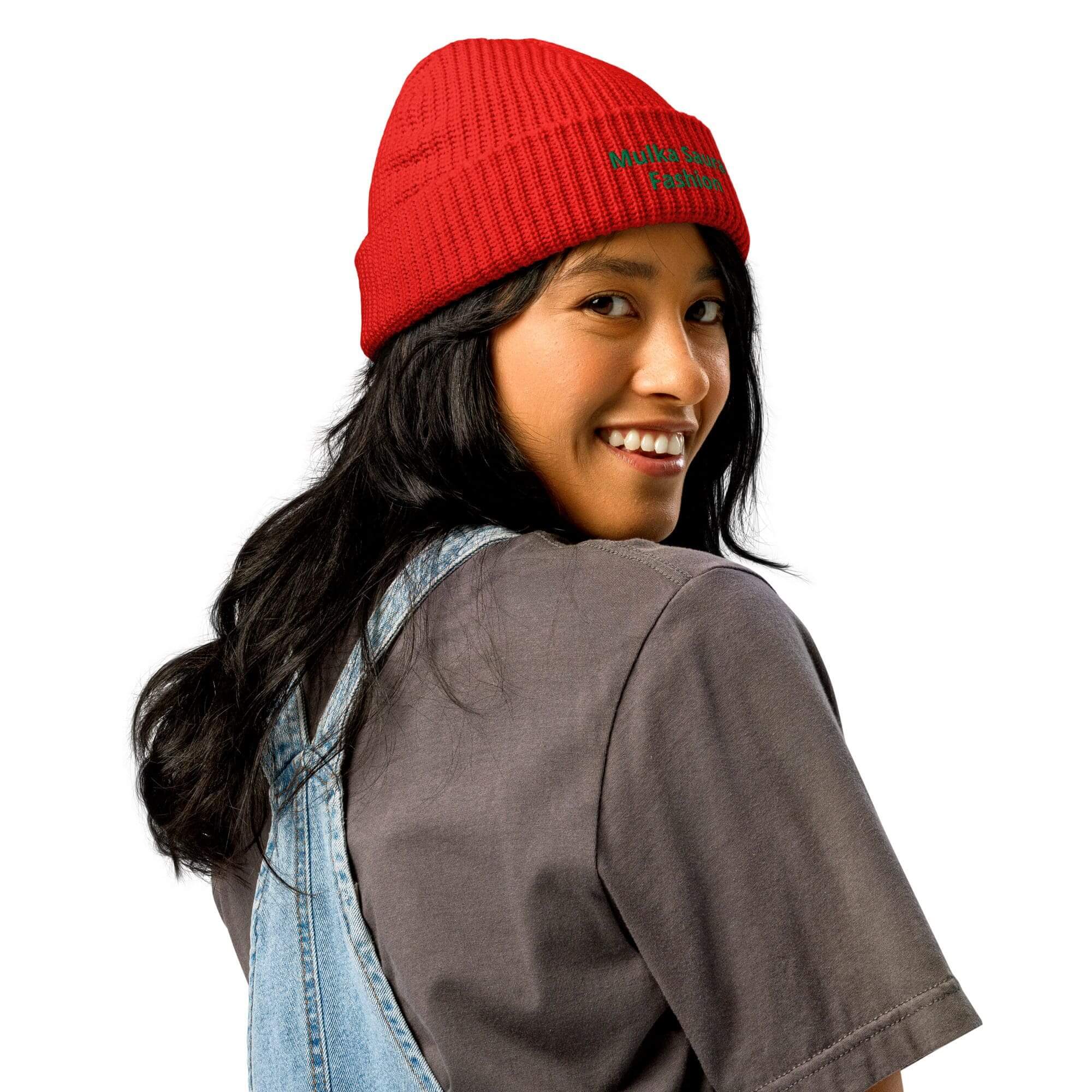 Smiling person in red beanie and overalls.
