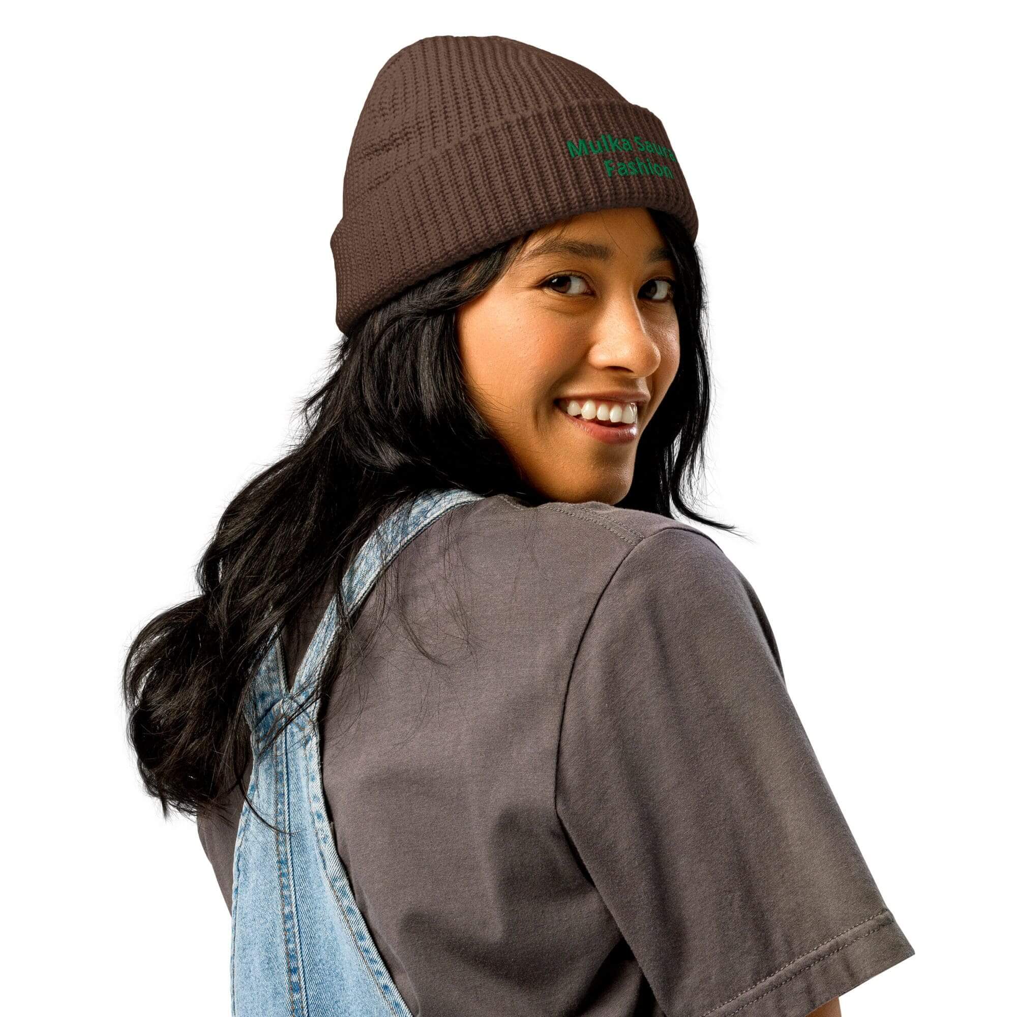 Smiling woman wearing beanie and overalls.
