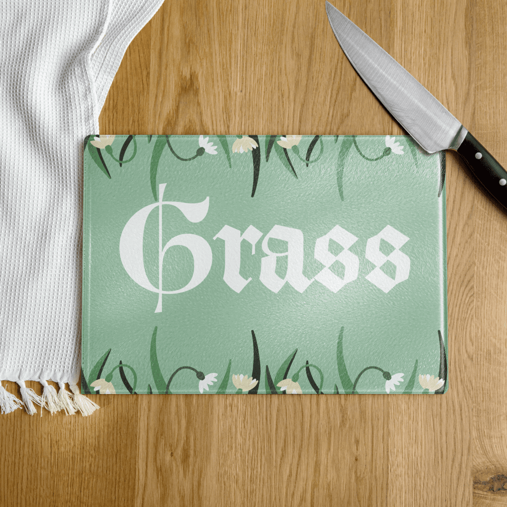 Green glass cutting board labeled "Grass