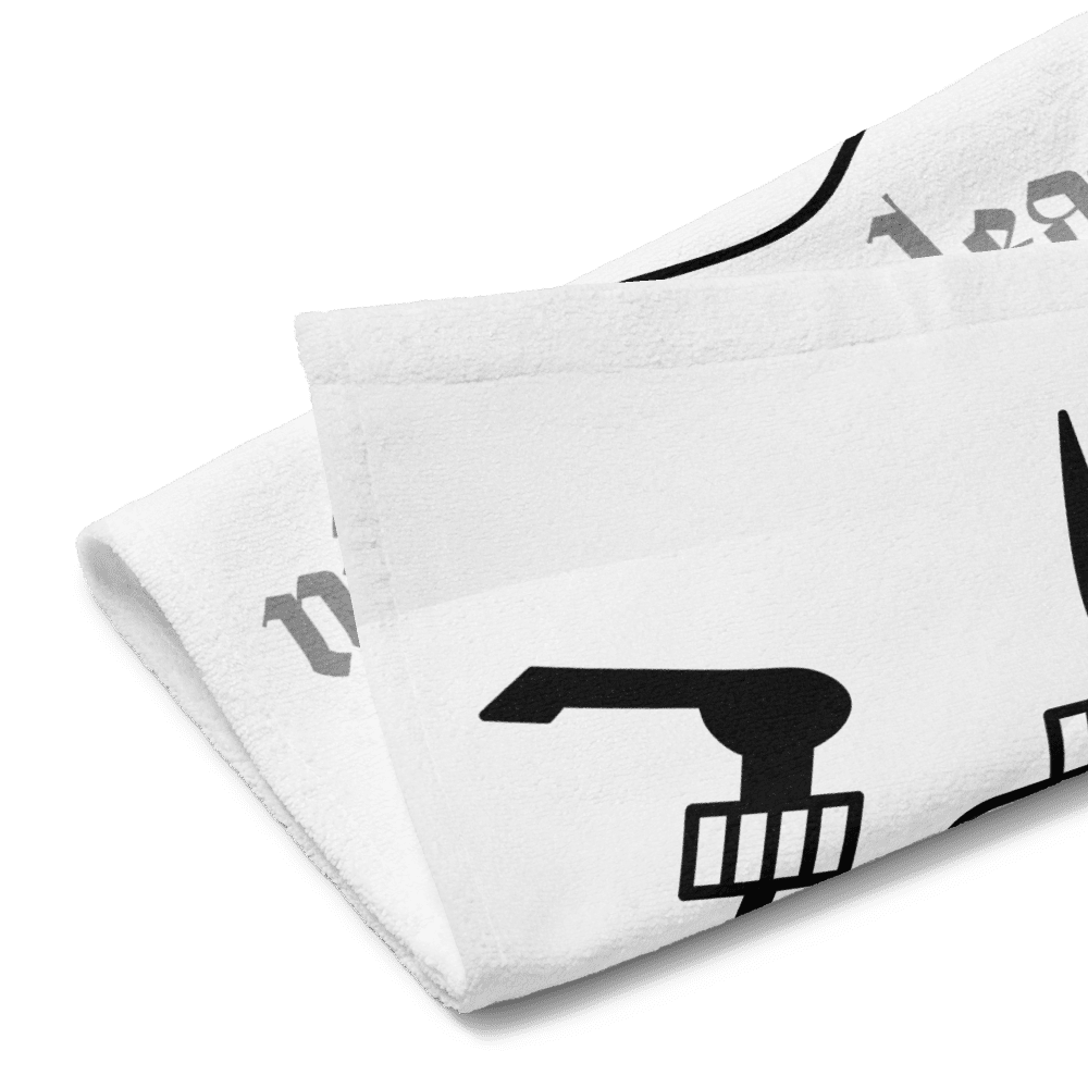 Folded white towel with black faucet print