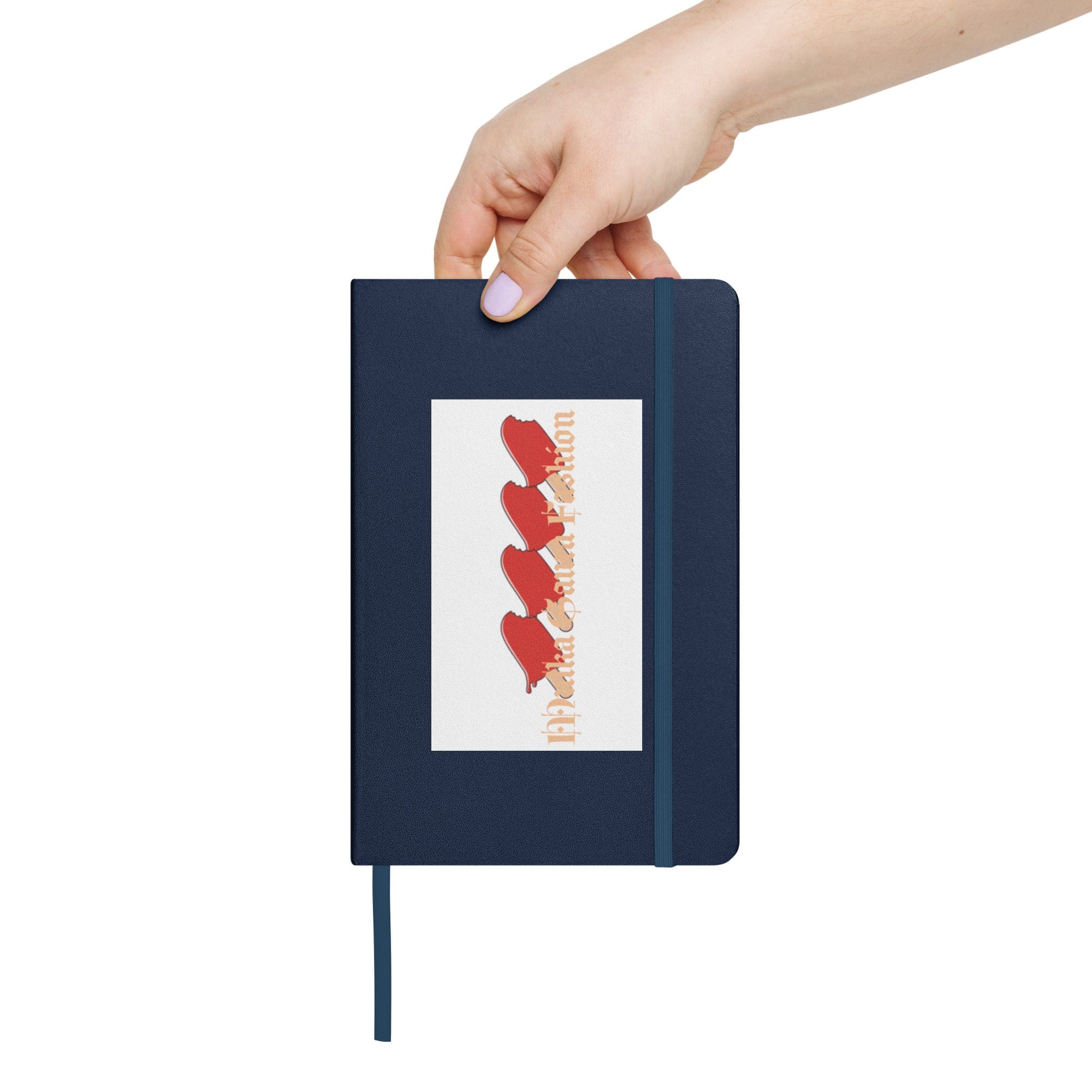 Hand holding a blue notebook.