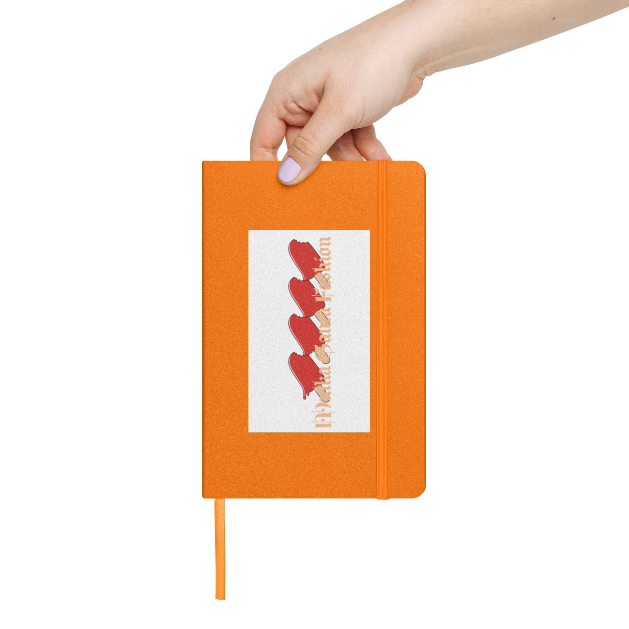 Hand holding an orange notebook upright.