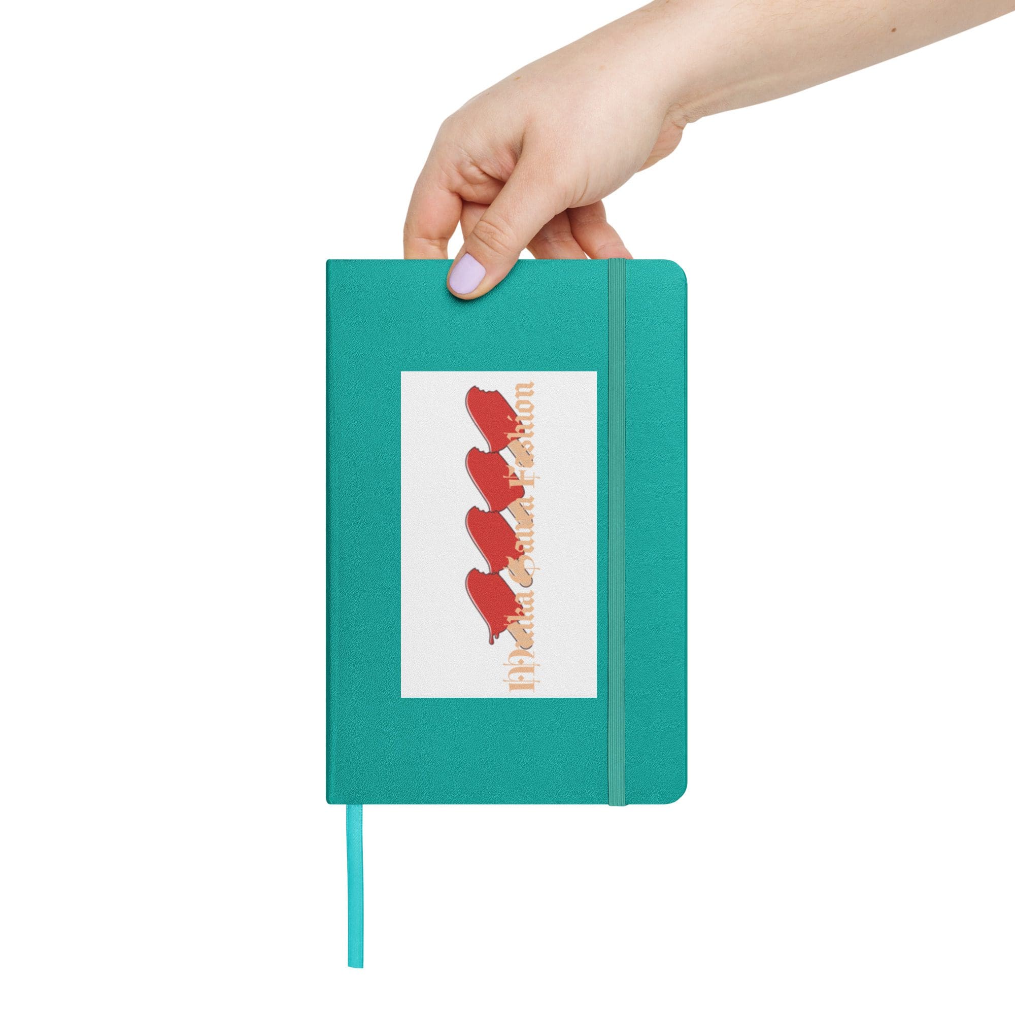 Hand holding teal notebook with sticker.