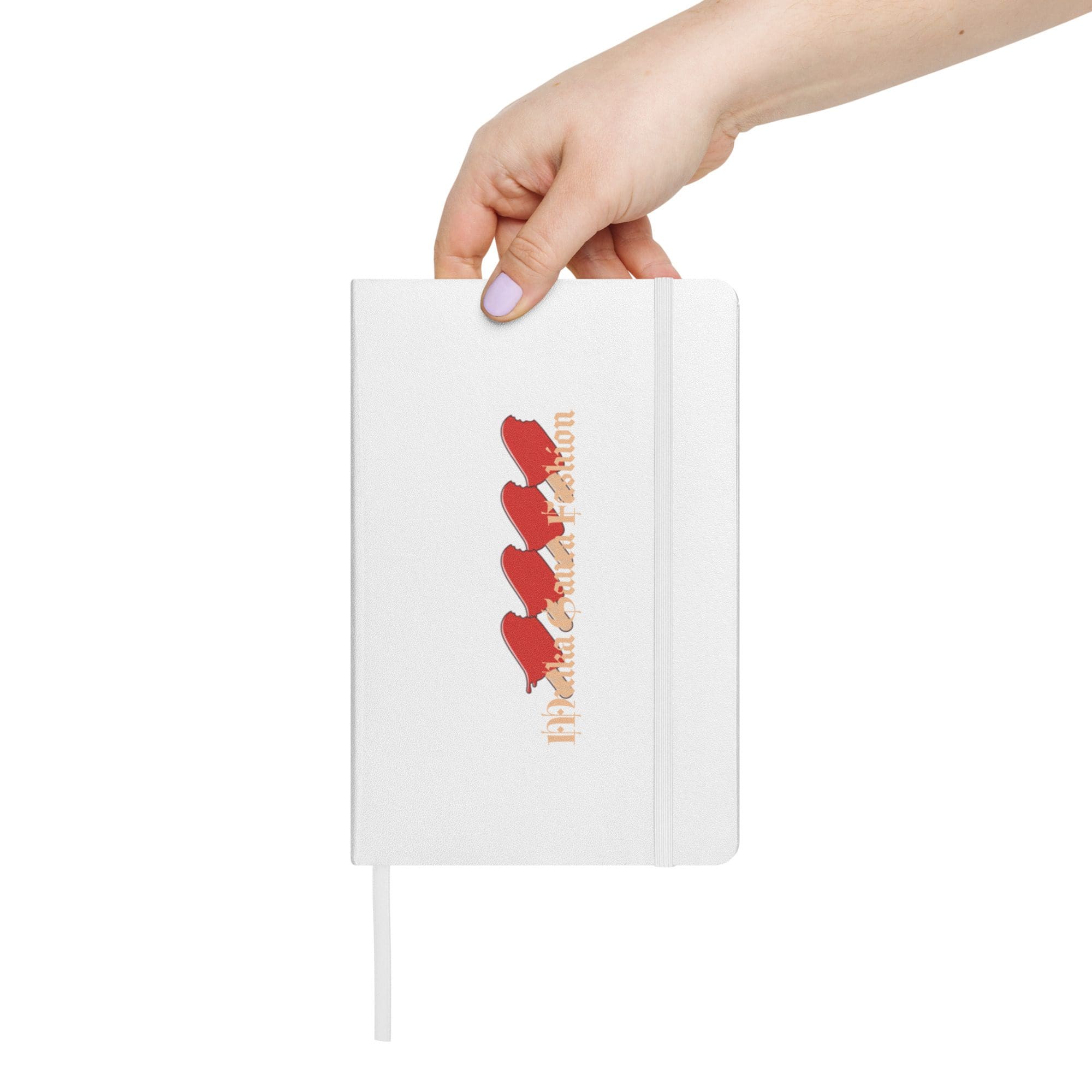 Hand holding notebook with red hearts design.