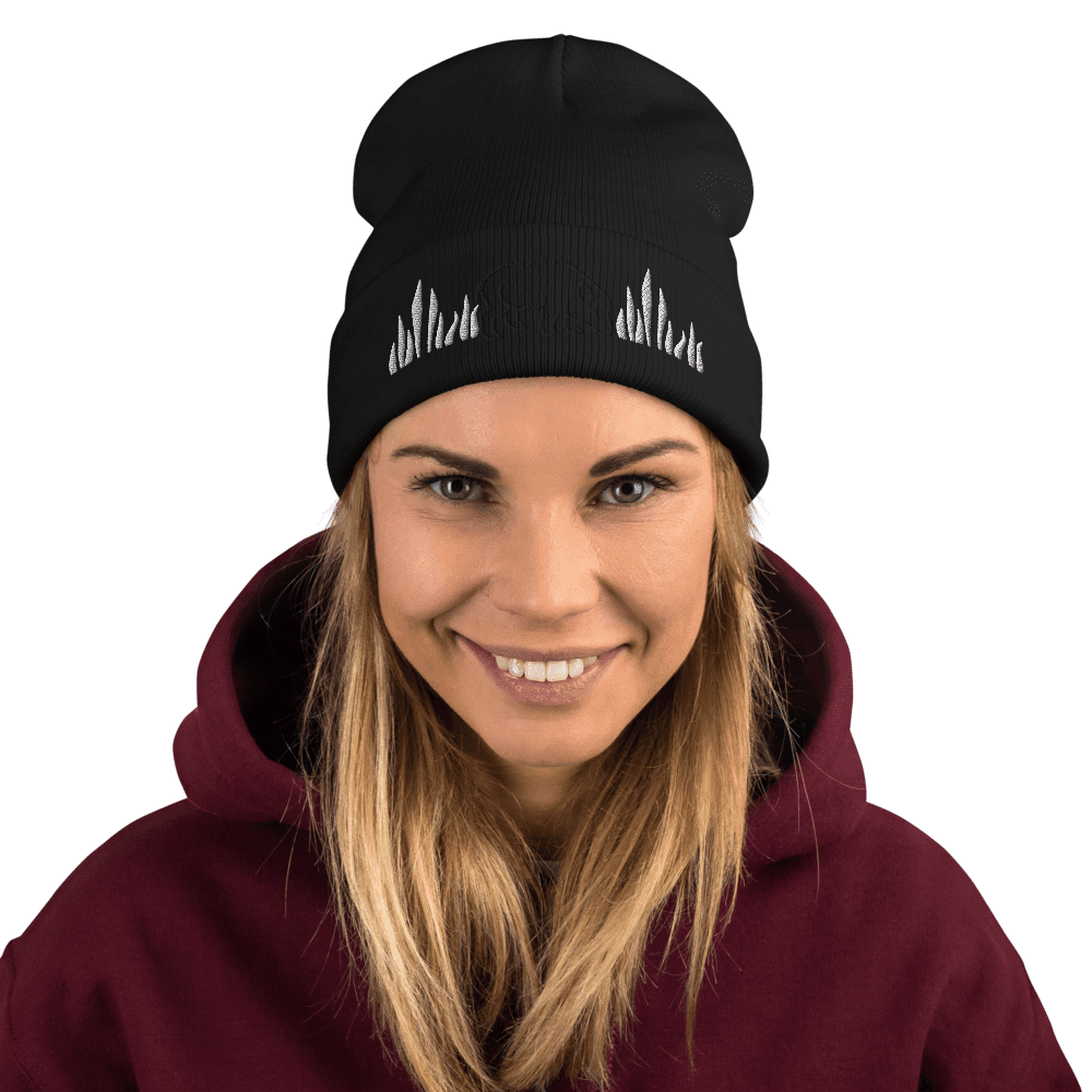 Woman smiling, wearing black beanie and hoodie.