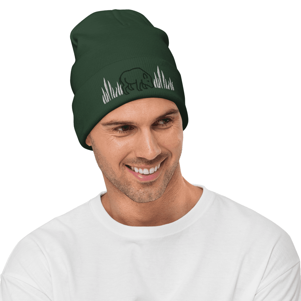 Man wearing green beanie with bear design.