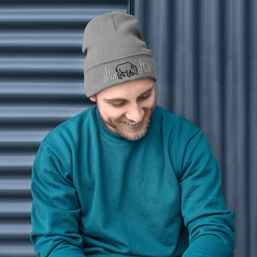 Man in teal sweater and gray beanie.