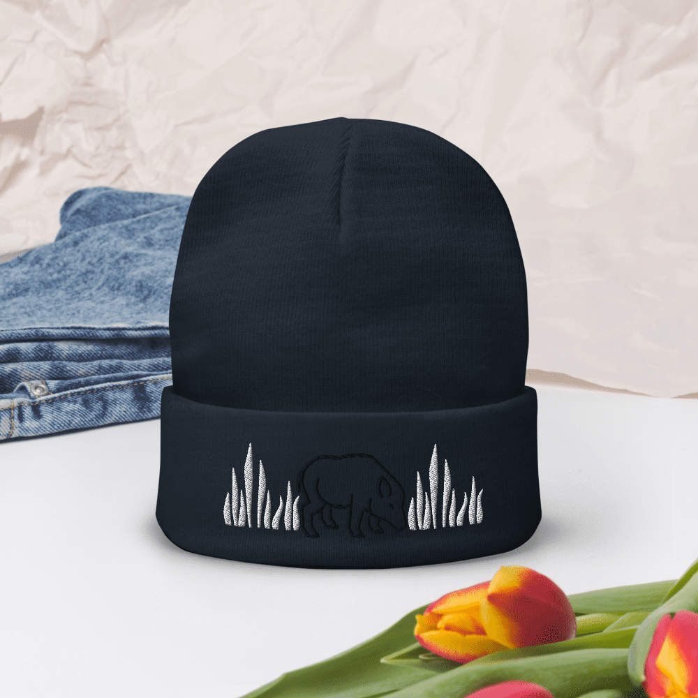 Black beanie with bear and grass embroidery.