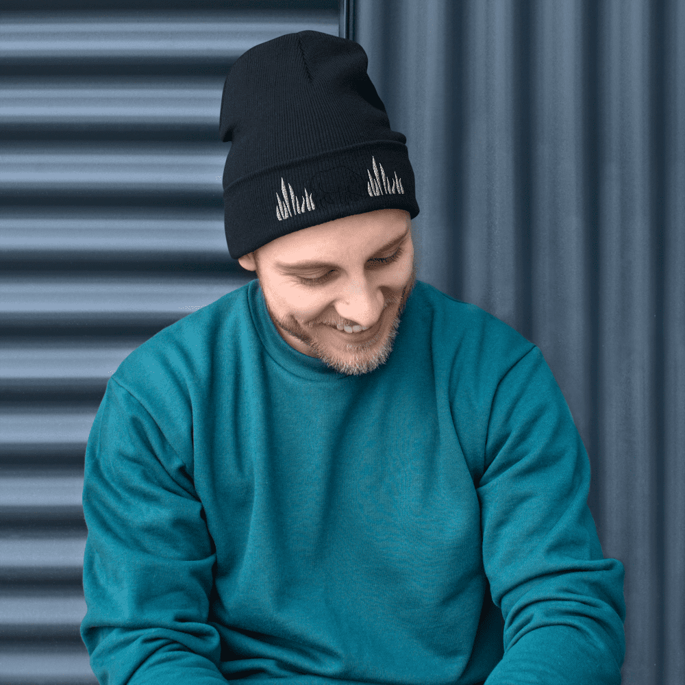 Man in teal sweater and black beanie.