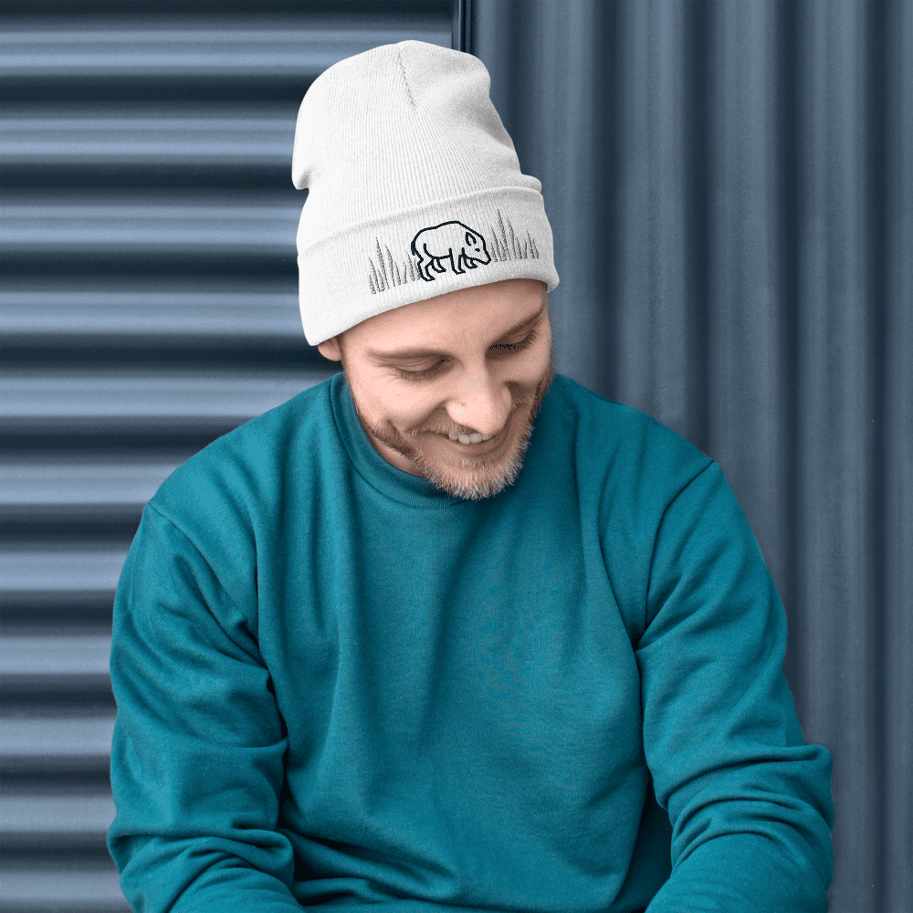 Man in blue sweater and white beanie.