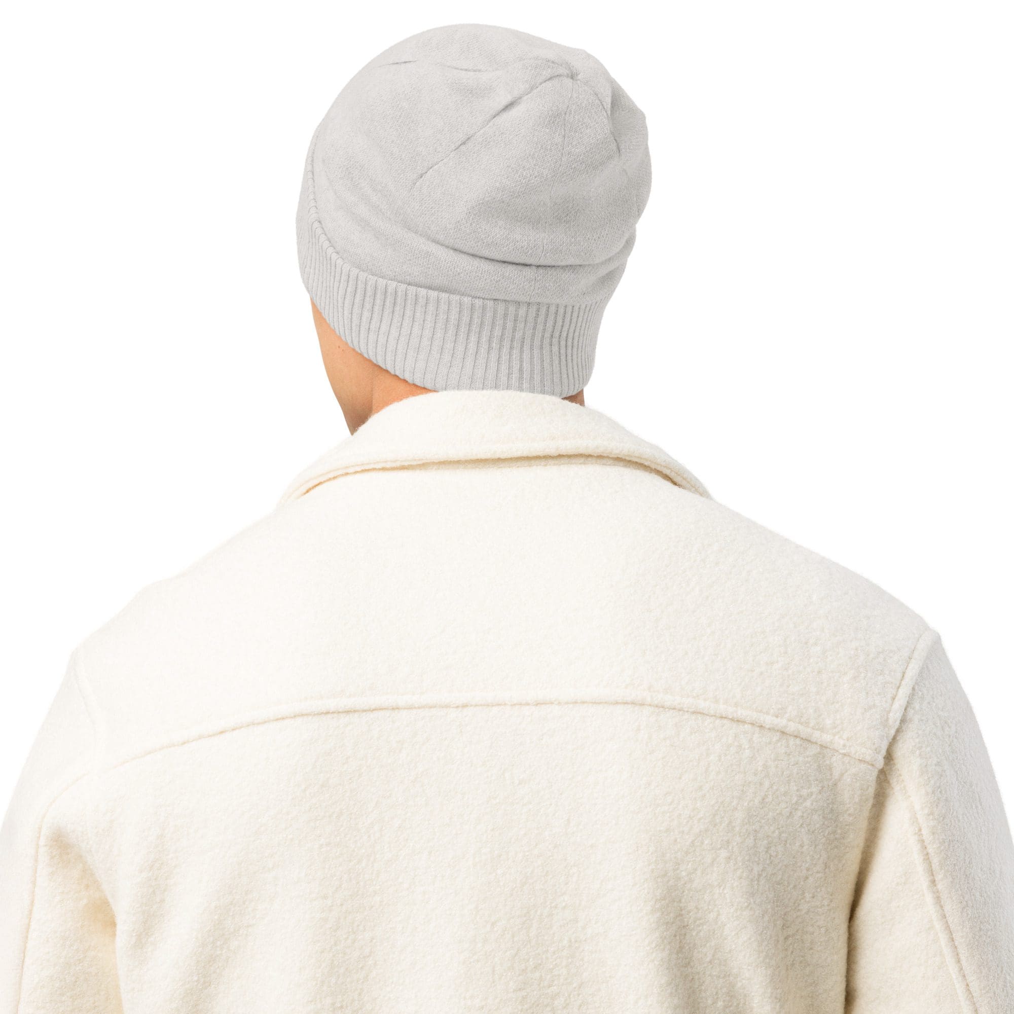 Man wearing white jacket and beanie, rear view.