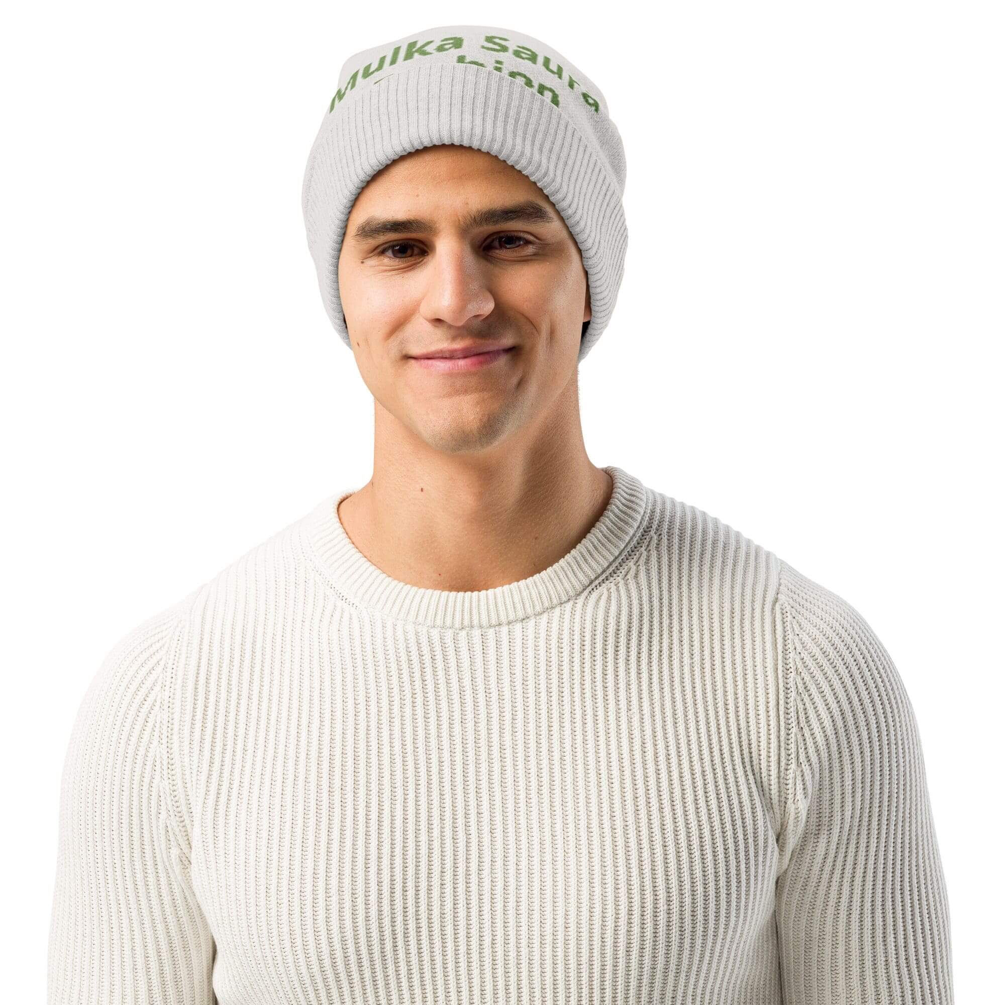 Man wearing gray beanie and white sweater.