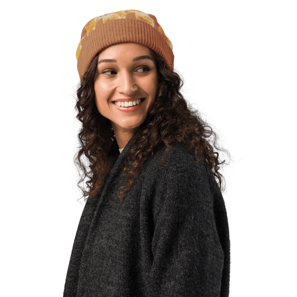 Smiling woman wearing a beanie and coat.